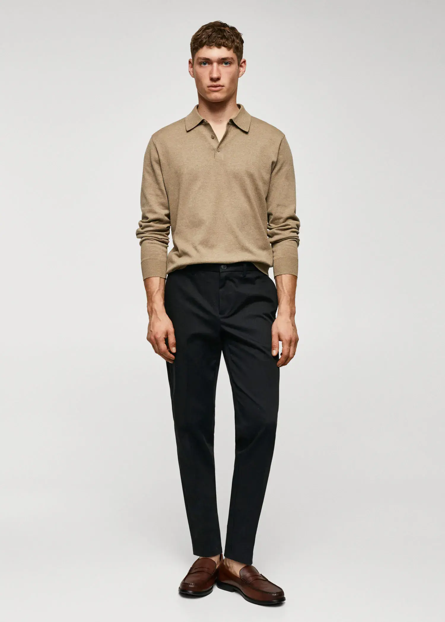 Mango Slim fit chino trousers. a man in a tan long sleeve shirt and black pants. 
