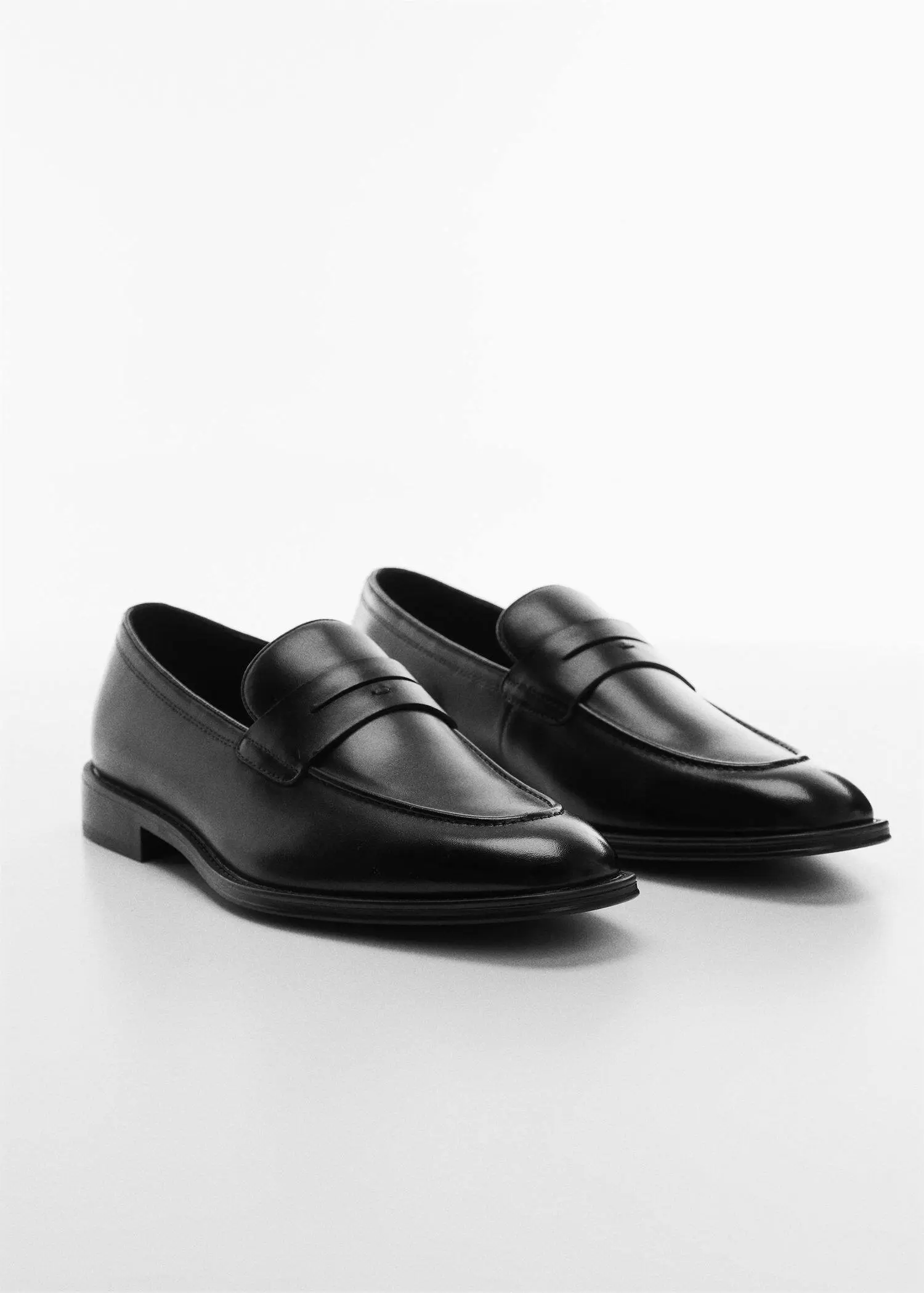 Mango Aged-leather loafers. a pair of black loafers on a white surface. 
