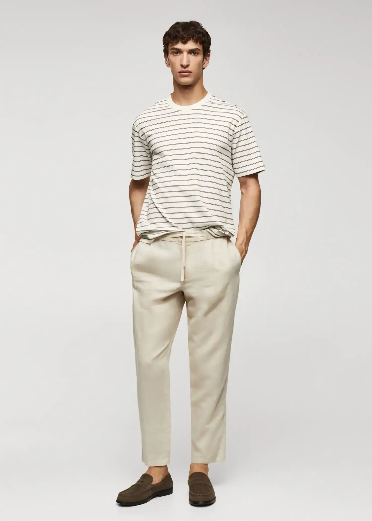 Mango Striped 100% cotton t-shirt. a man in a striped t-shirt and a pair of pants. 