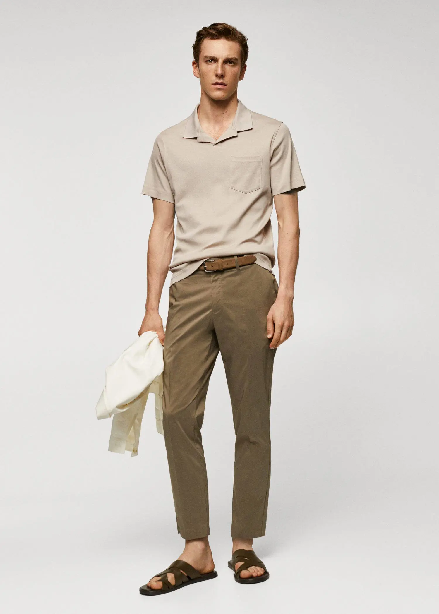 Mango 100% cotton polo shirt with pocket. a man in a tan shirt and brown pants. 
