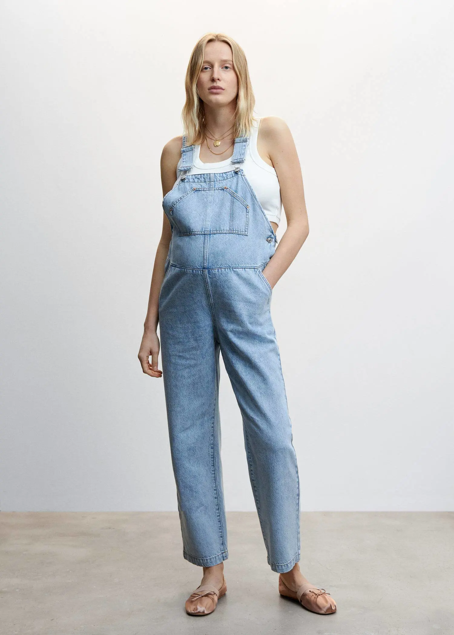 Mango Maternity denim dungarees. a woman wearing a pair of blue overalls. 