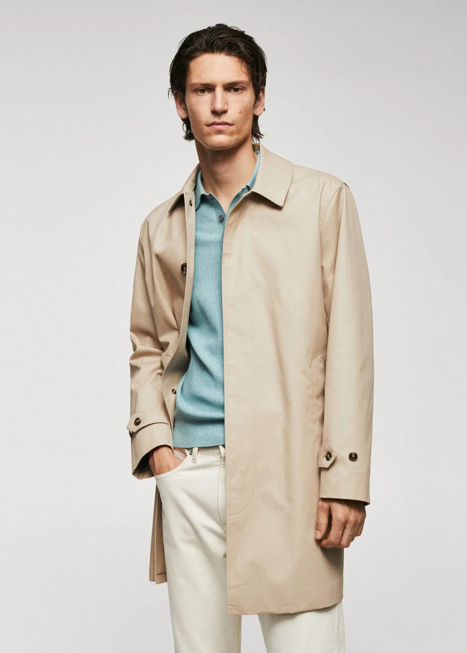 Mango Water-repellent cotton trench coat. a man wearing a tan coat and white pants. 