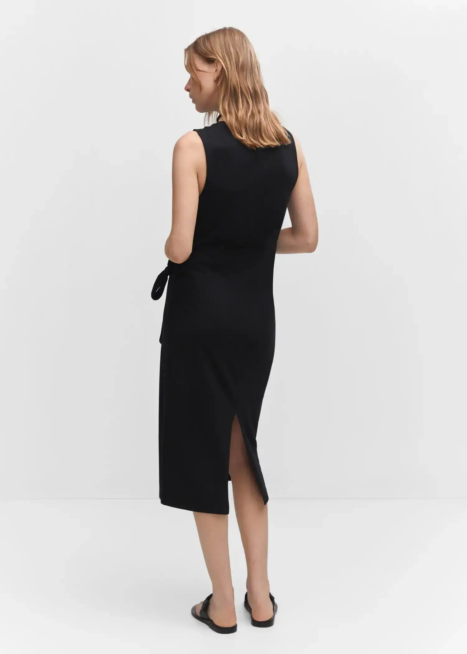 Mango Bow cut-out detail dress. a woman is wearing a black dress with a bow. 