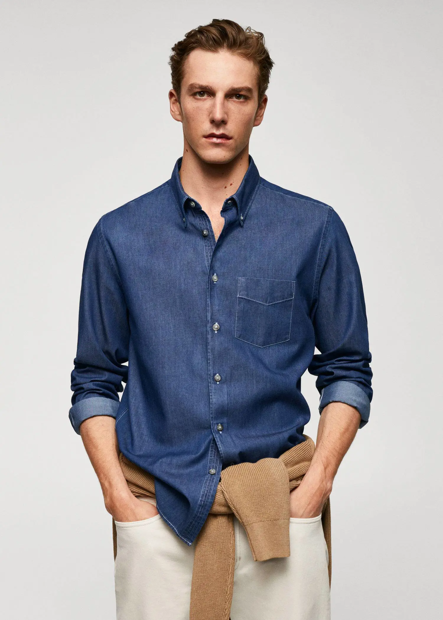 Mango Slim-fit denim skirt with pockets. a young man wearing a blue shirt and brown pants. 