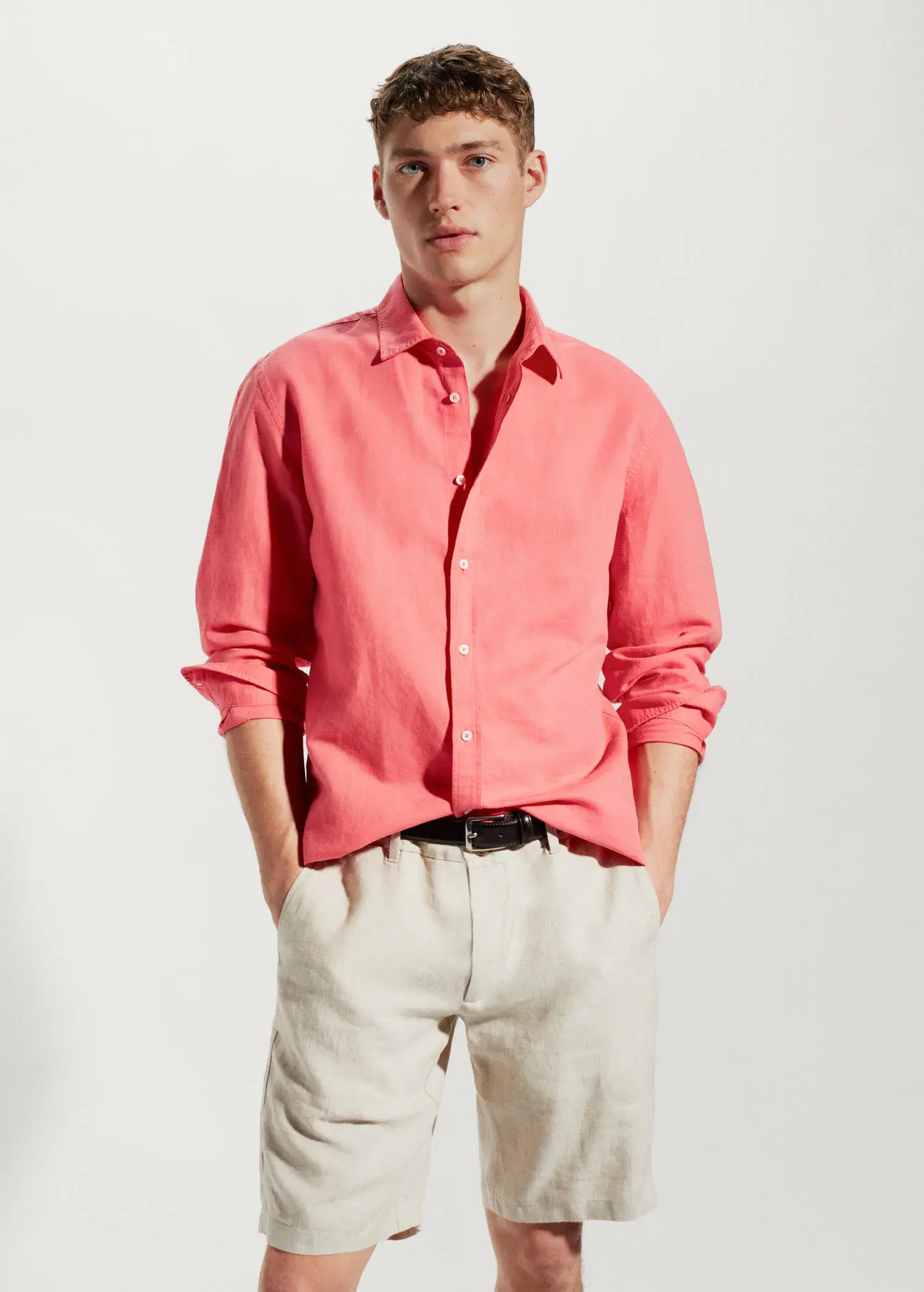 Mango Regular-fit linen cotton shirt. a man wearing a pink shirt and white pants. 