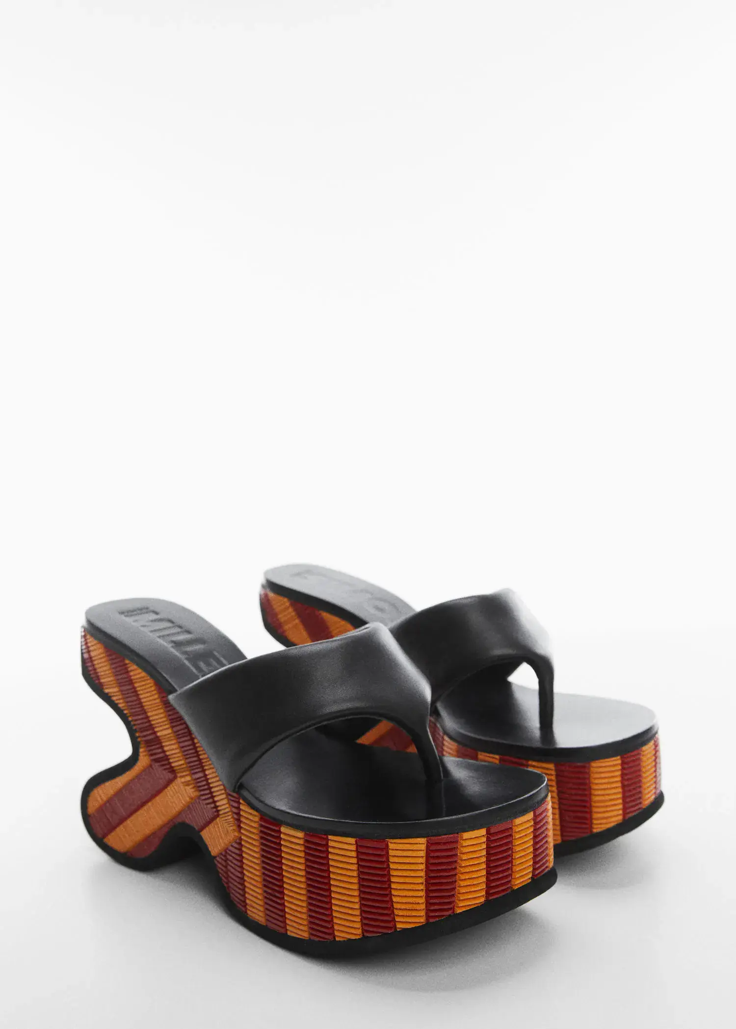Mango Irregular leather platform sandals. a pair of black and orange sandals on a white surface. 