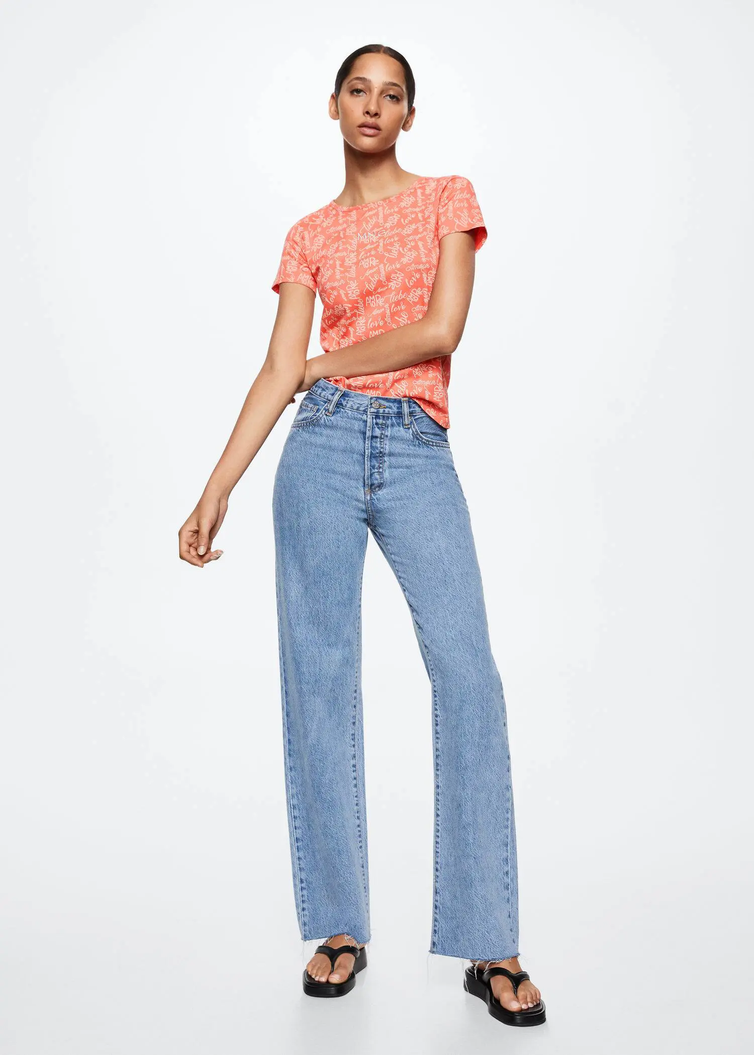 Mango Printed cotton-blend T-shirt. a woman in a pink shirt and blue jeans. 