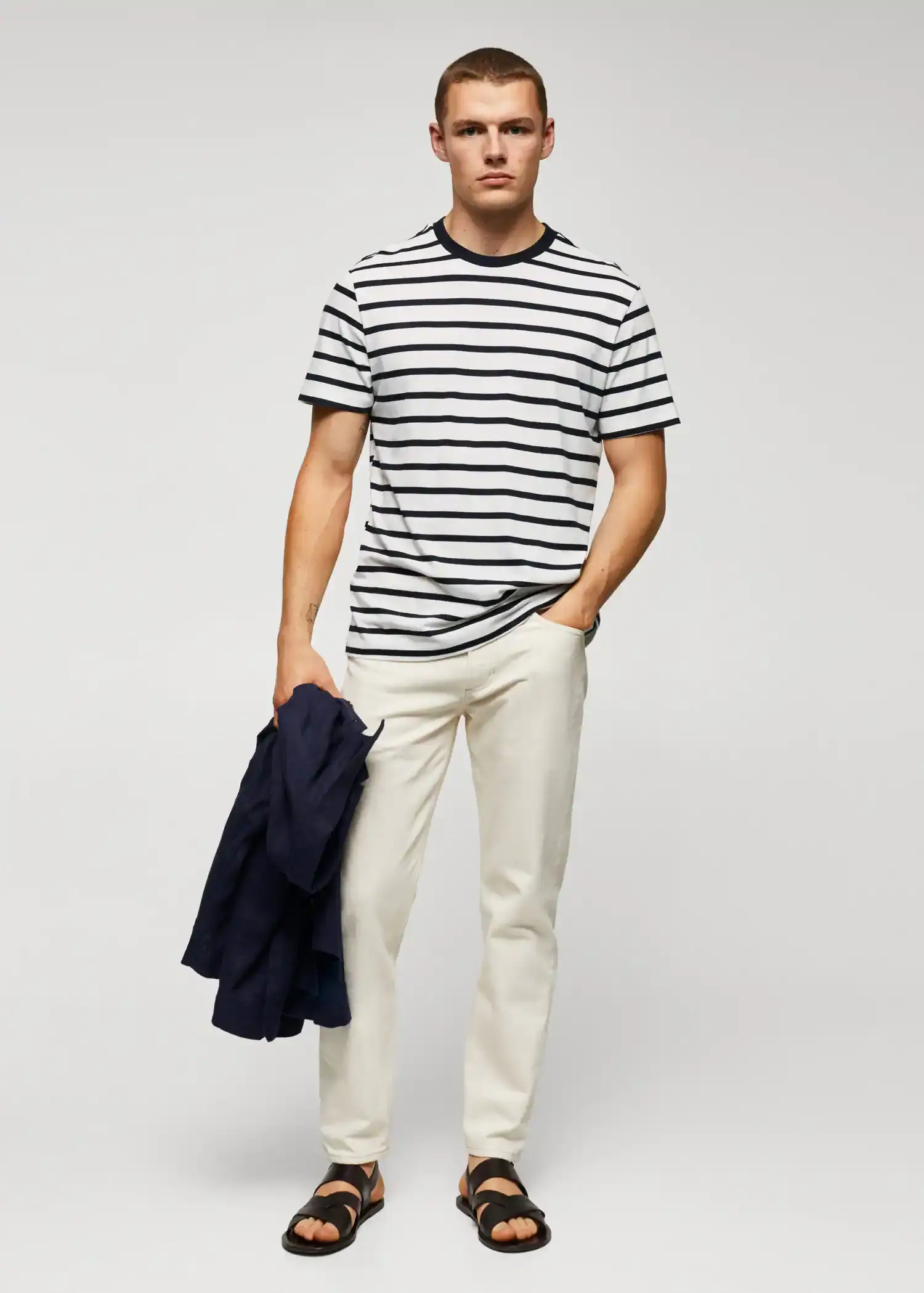 Mango Cotton-modal striped t-shirt. a young man wearing a striped shirt and white pants. 