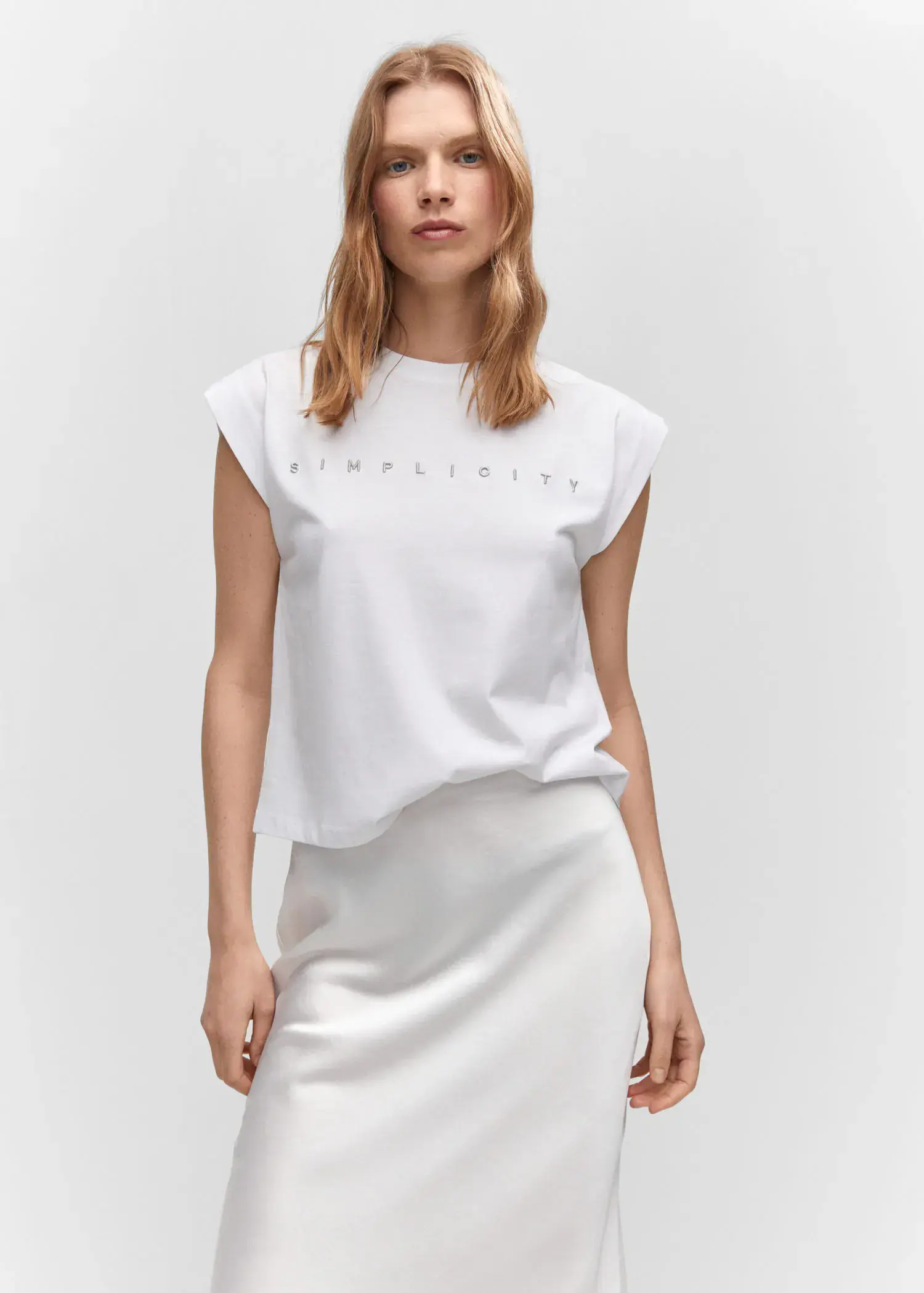 Mango Message cotton T-shirt. a woman in a white top and a white skirt. 