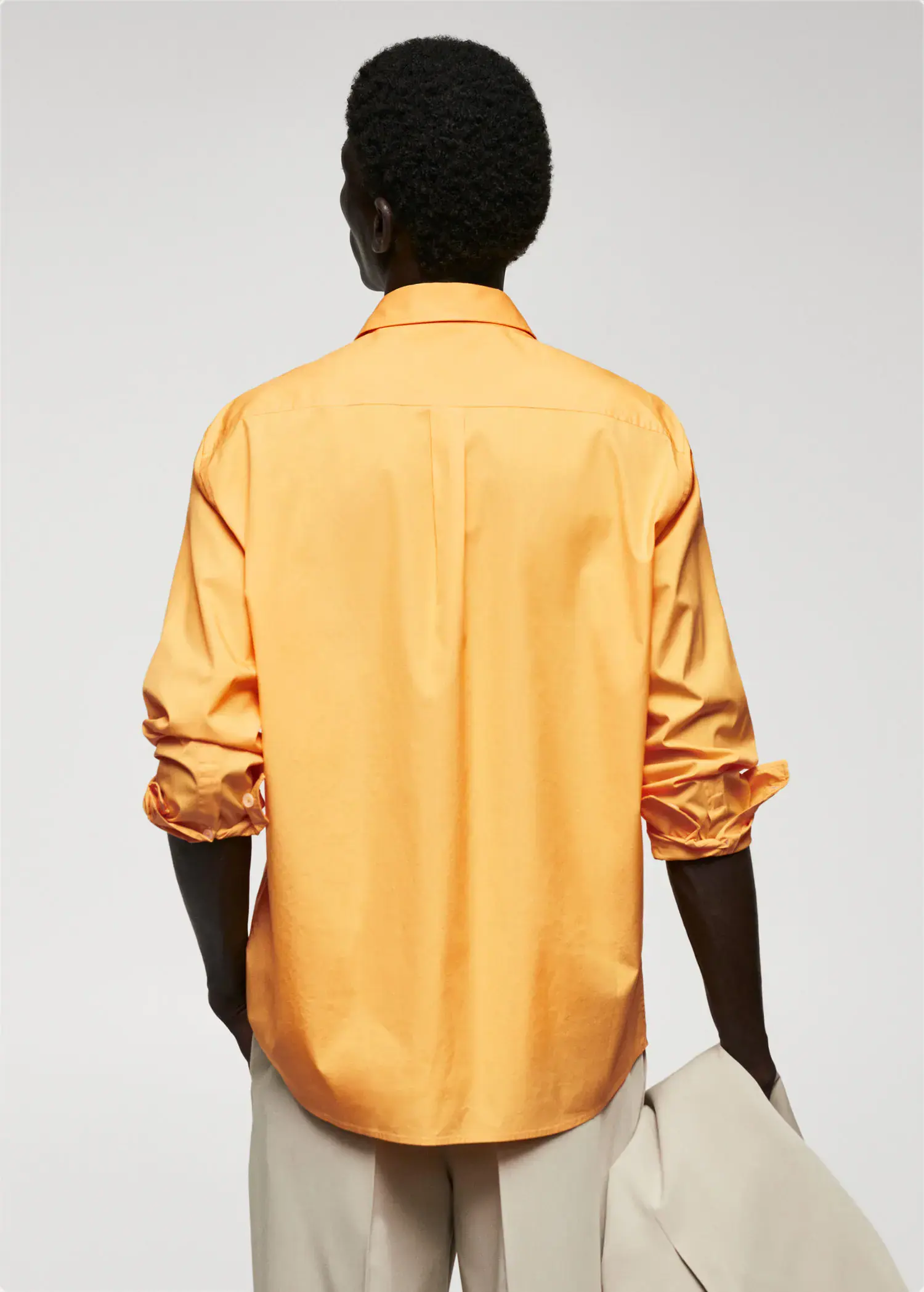 Mango 100% cotton pocket shirt. a person wearing a yellow shirt and holding a book. 