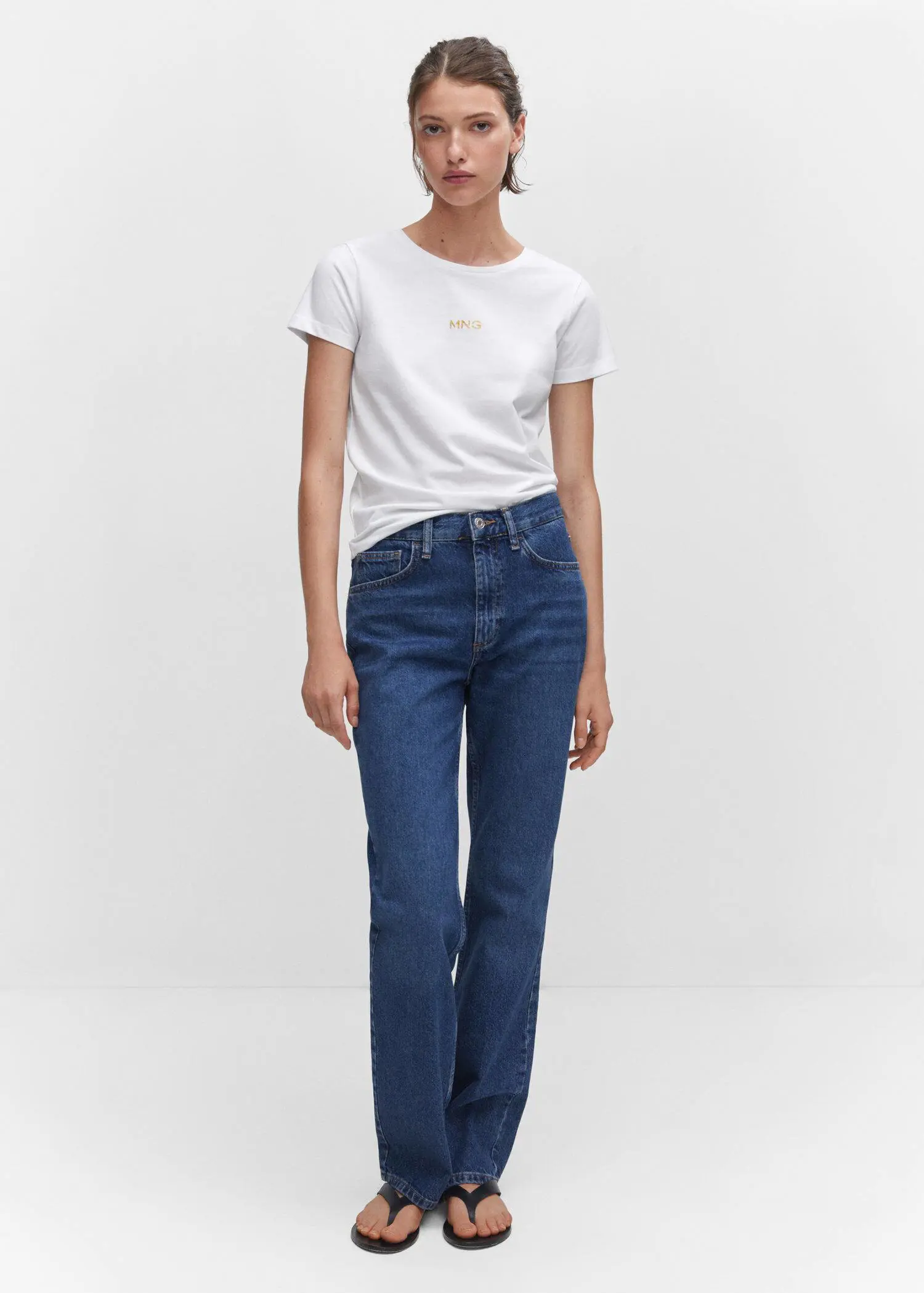 Mango Metallic logo T-shirt. a woman in white shirt and blue jeans. 