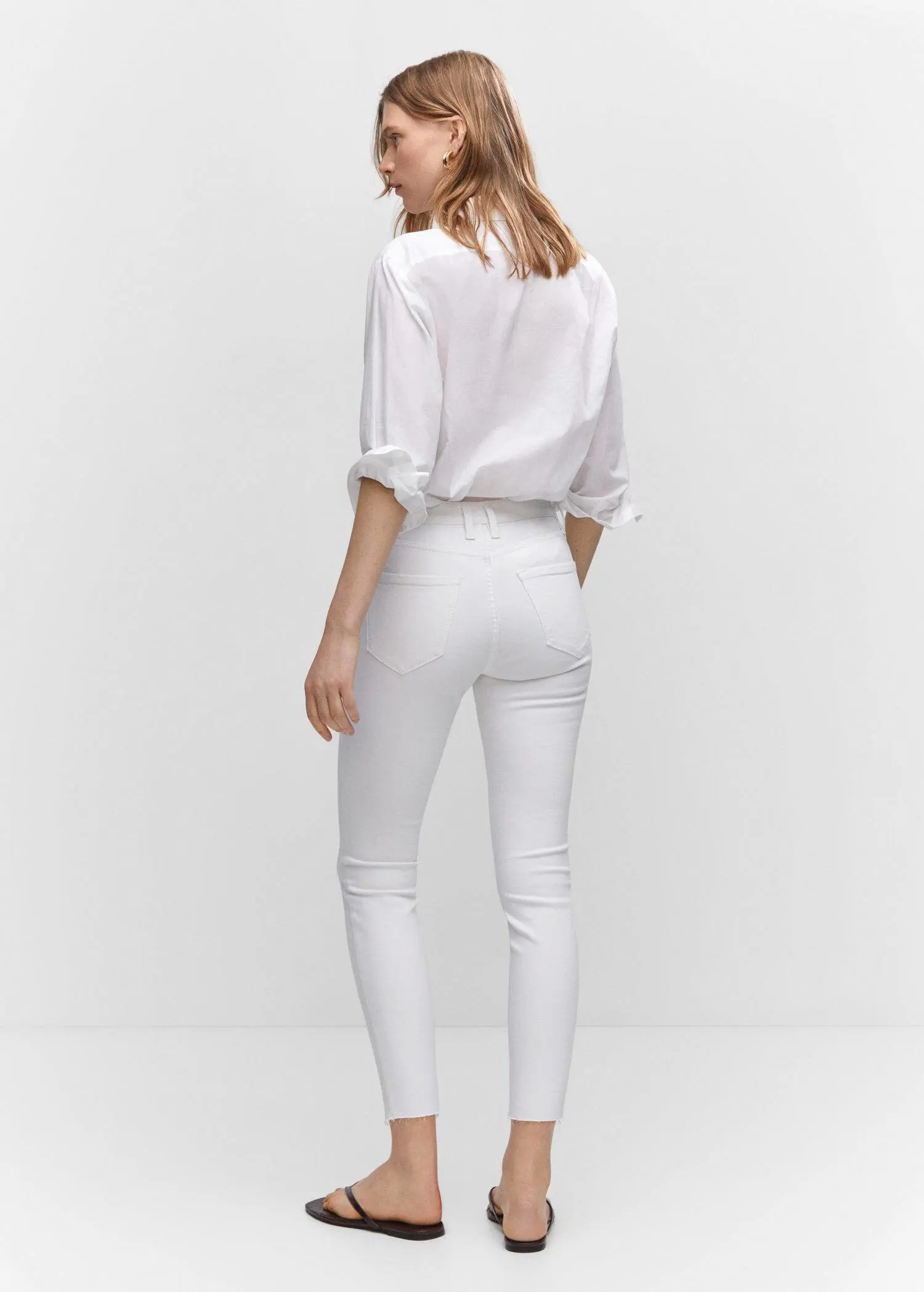 Mango Skinny cropped jeans. a woman wearing white pants and a white shirt. 