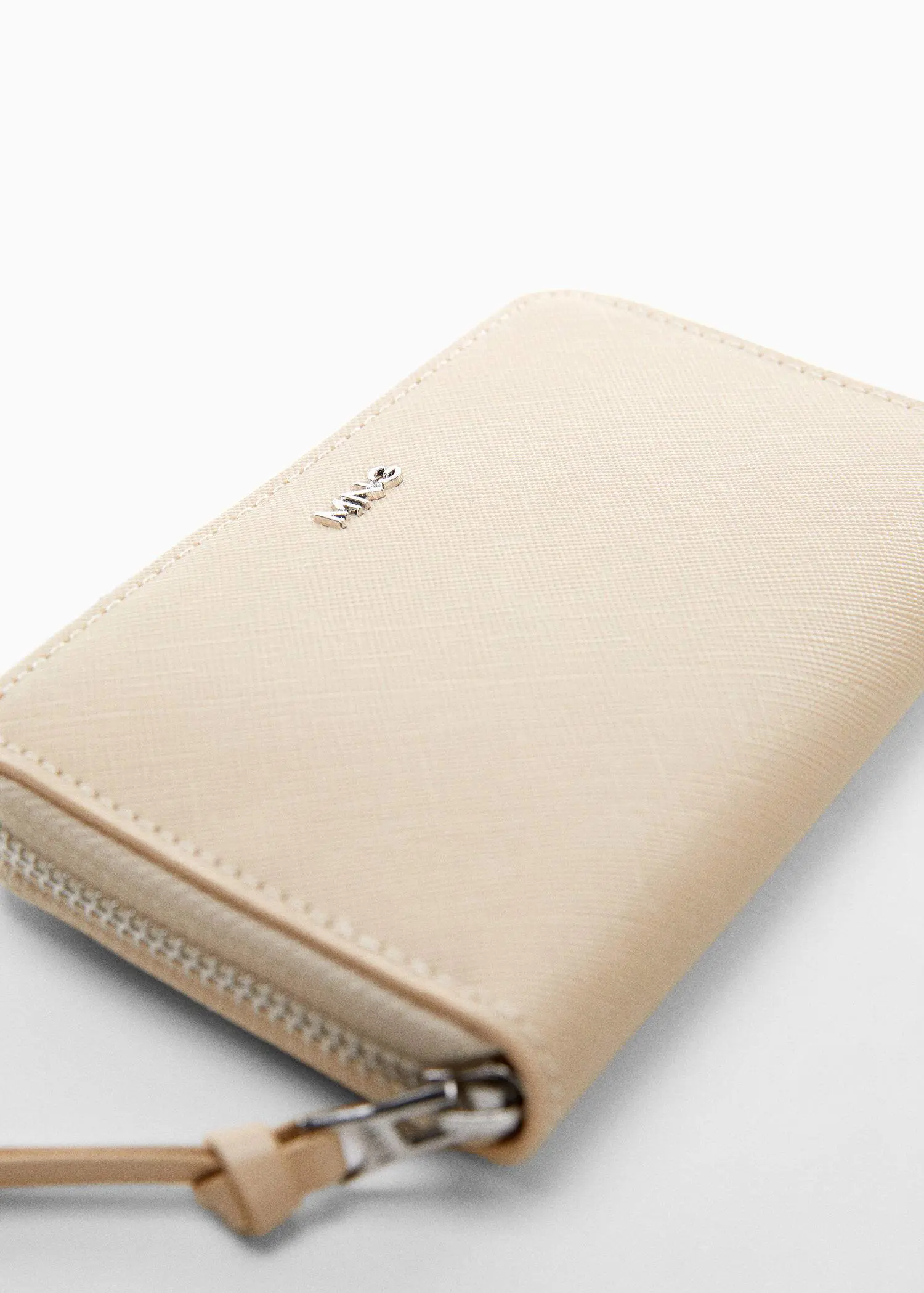 Mango Saffiano-effect wallet. a beige wallet sitting on top of a white table. 
