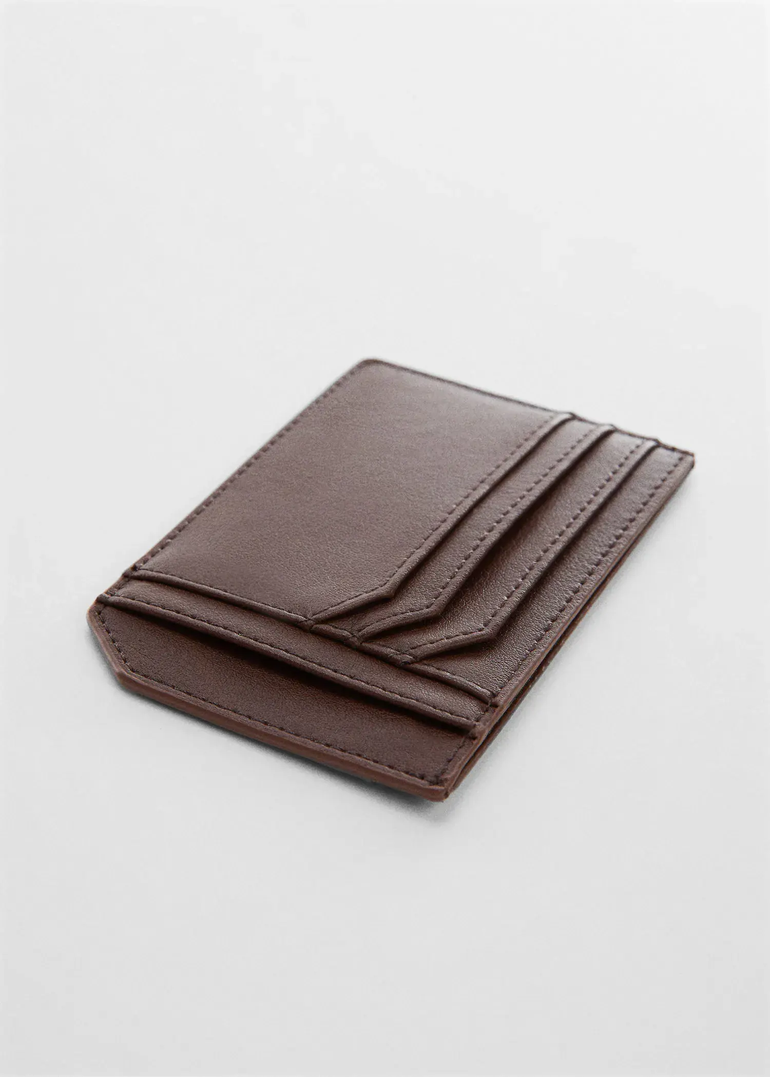 Mango Anti-contactless leather-effect card holder. a brown wallet is sitting on a table. 