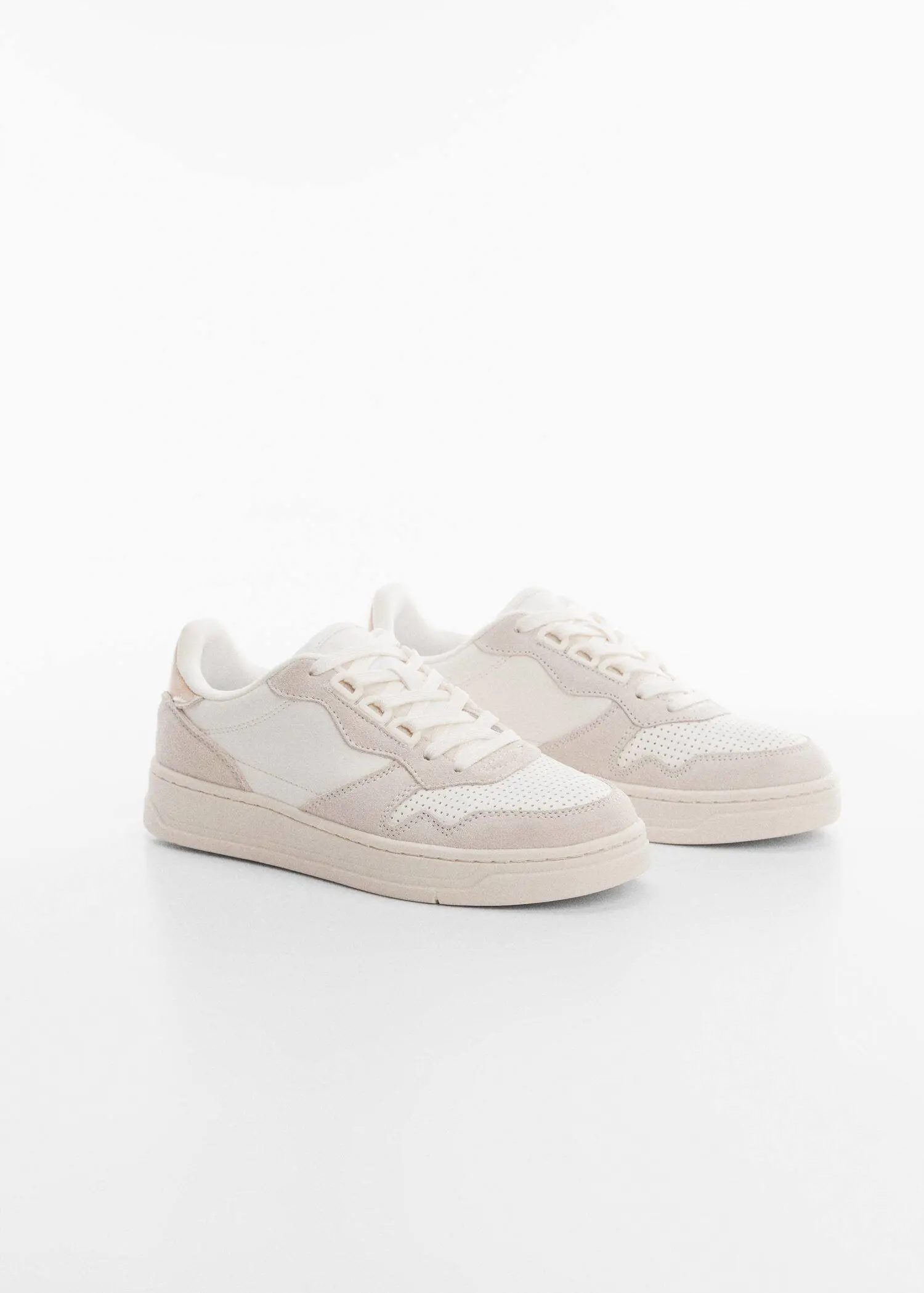 Mango Panels leather sneakers. a pair of white sneakers on top of a white surface. 