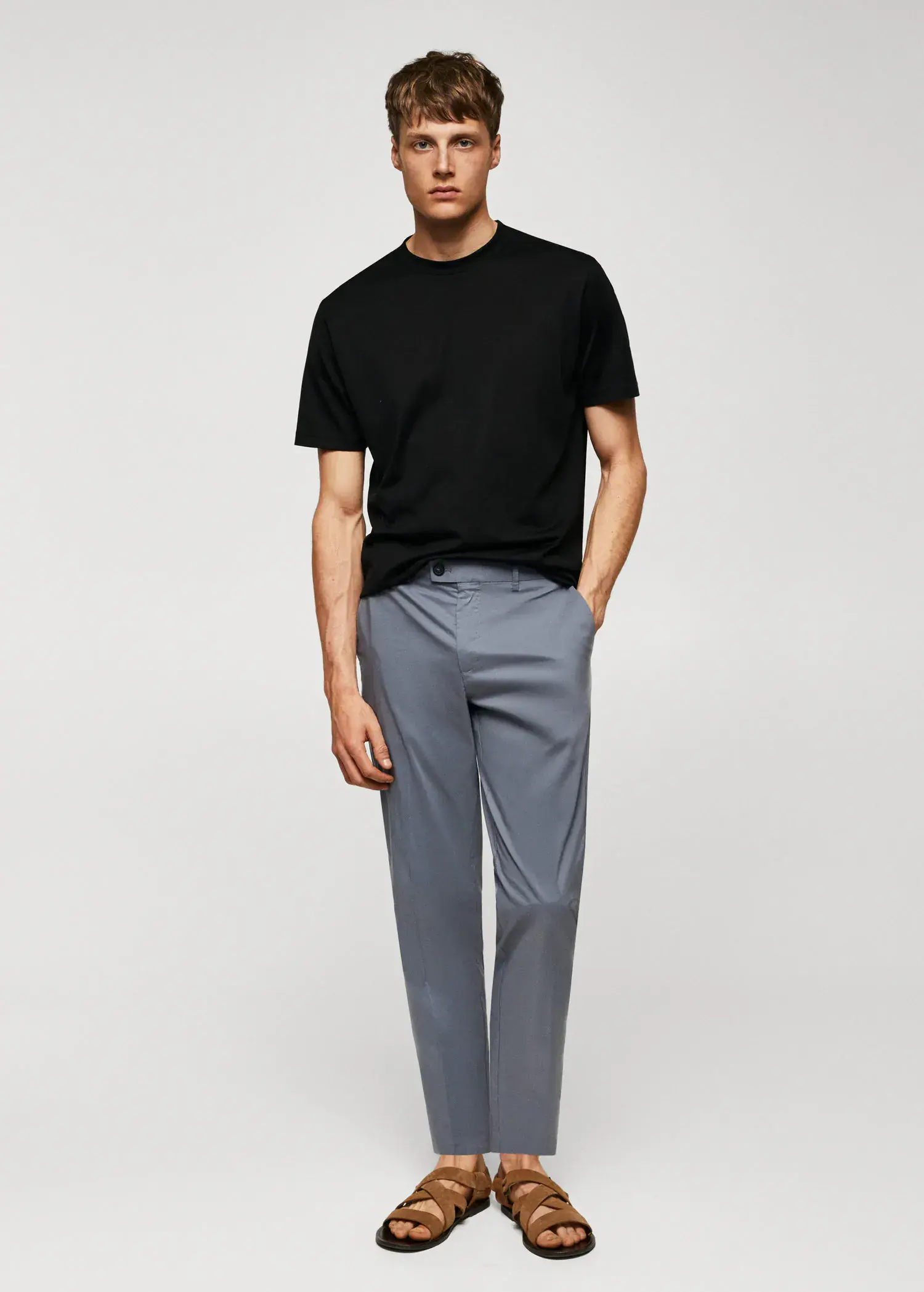 Mango Mercerised regular-fit t-shirt. a man in a black shirt and gray pants. 