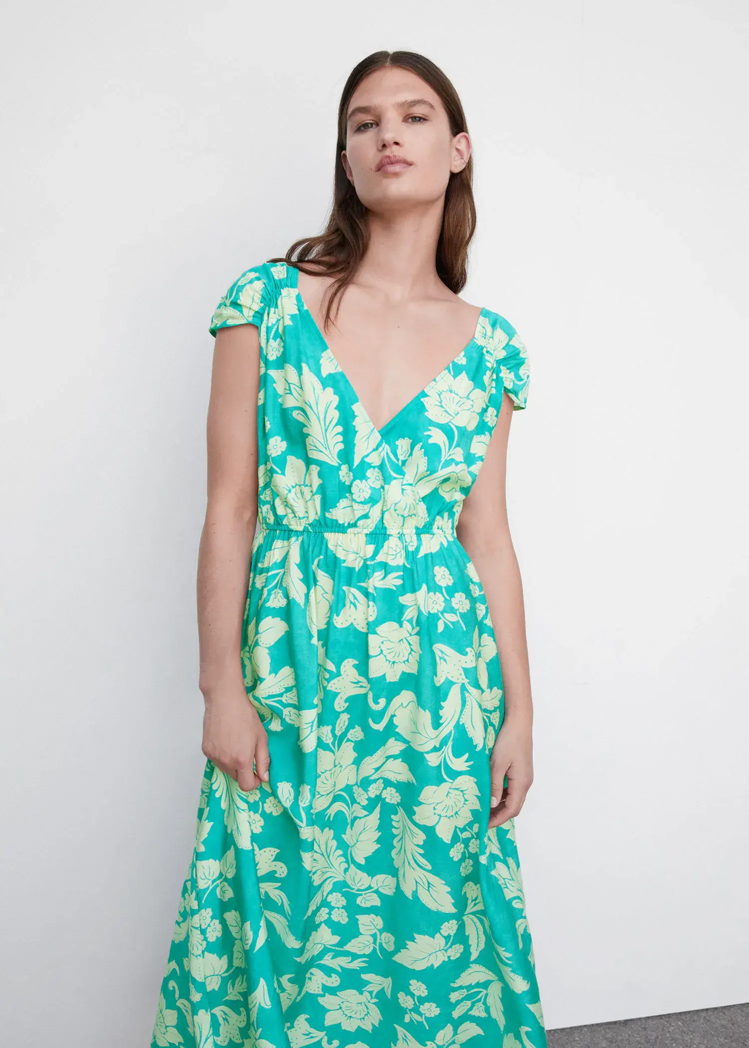 Mango Floral wrap neckline dress. a woman wearing a green floral print dress. 