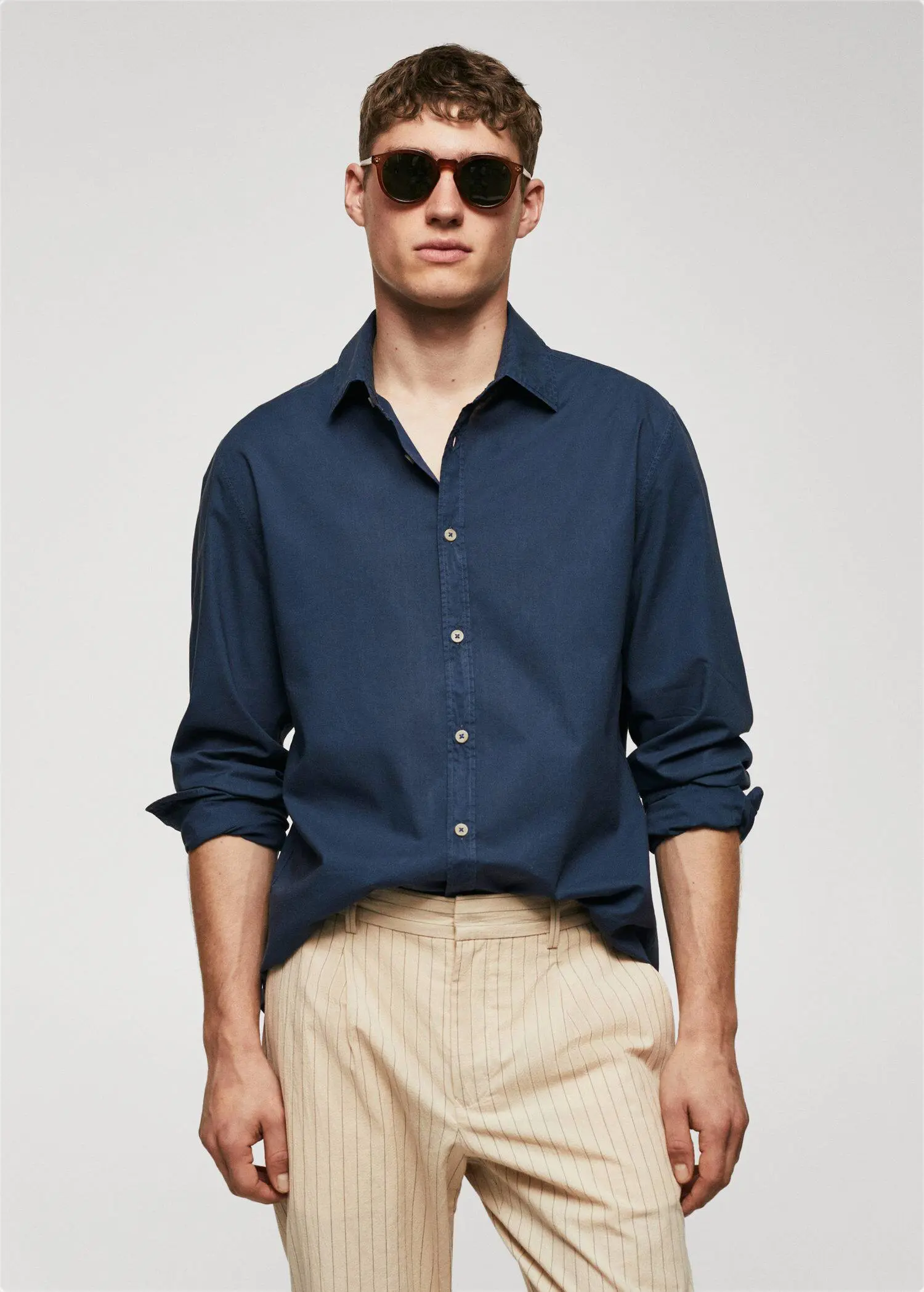 Mango Regular-fit cotton voile shirt. a man wearing a blue shirt and beige pants. 