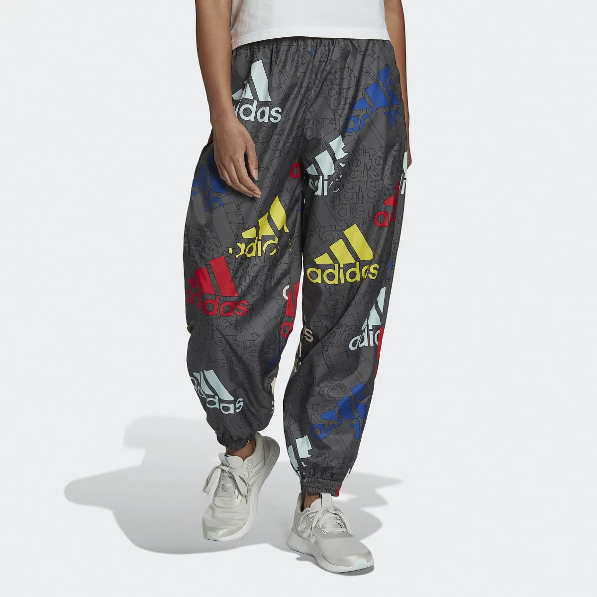 Adidas Essentials Multi-Colored Logo Loose Fit Woven Pants. 1