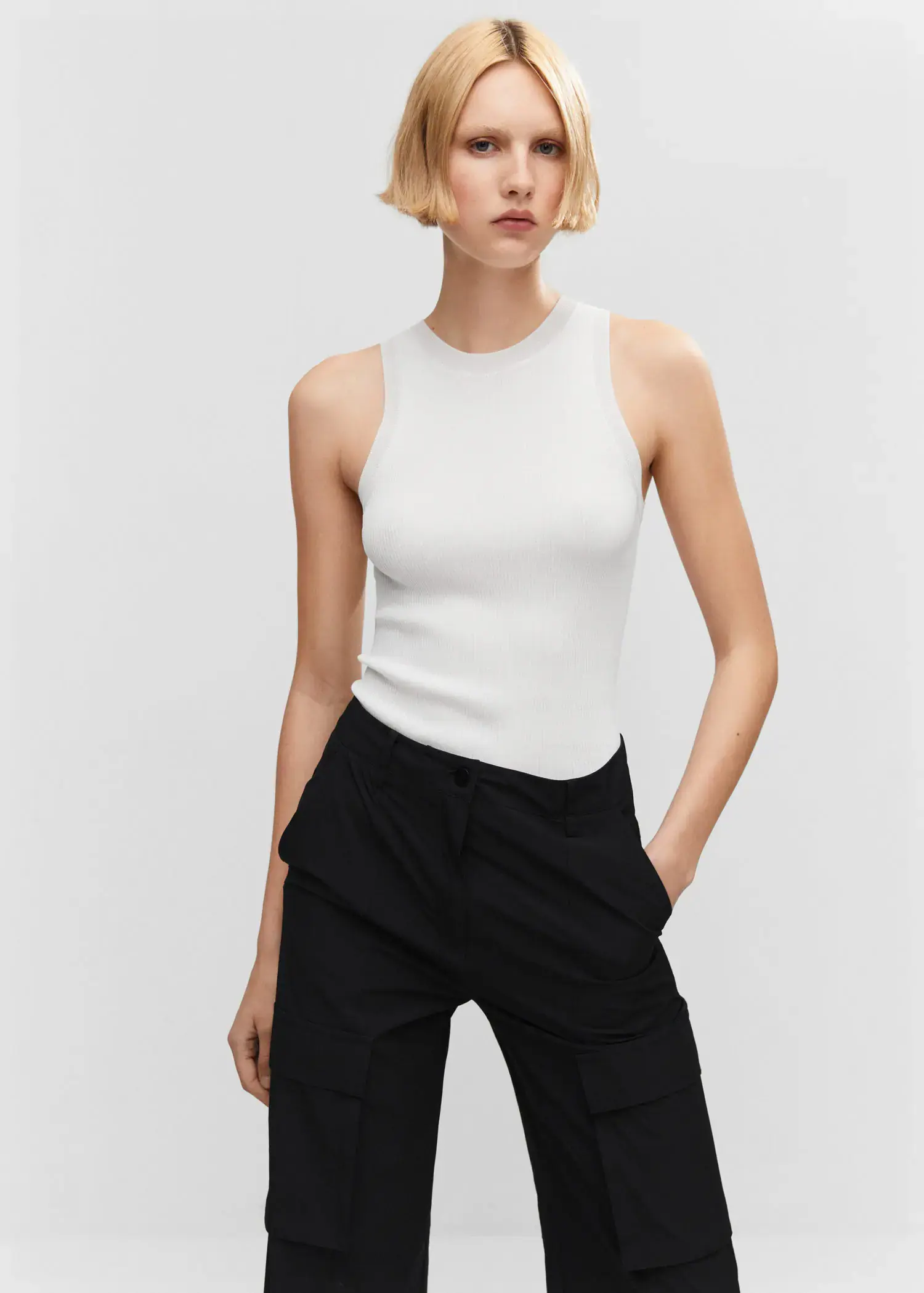 Mango Ribbed knit top. a woman wearing a white top and black pants. 