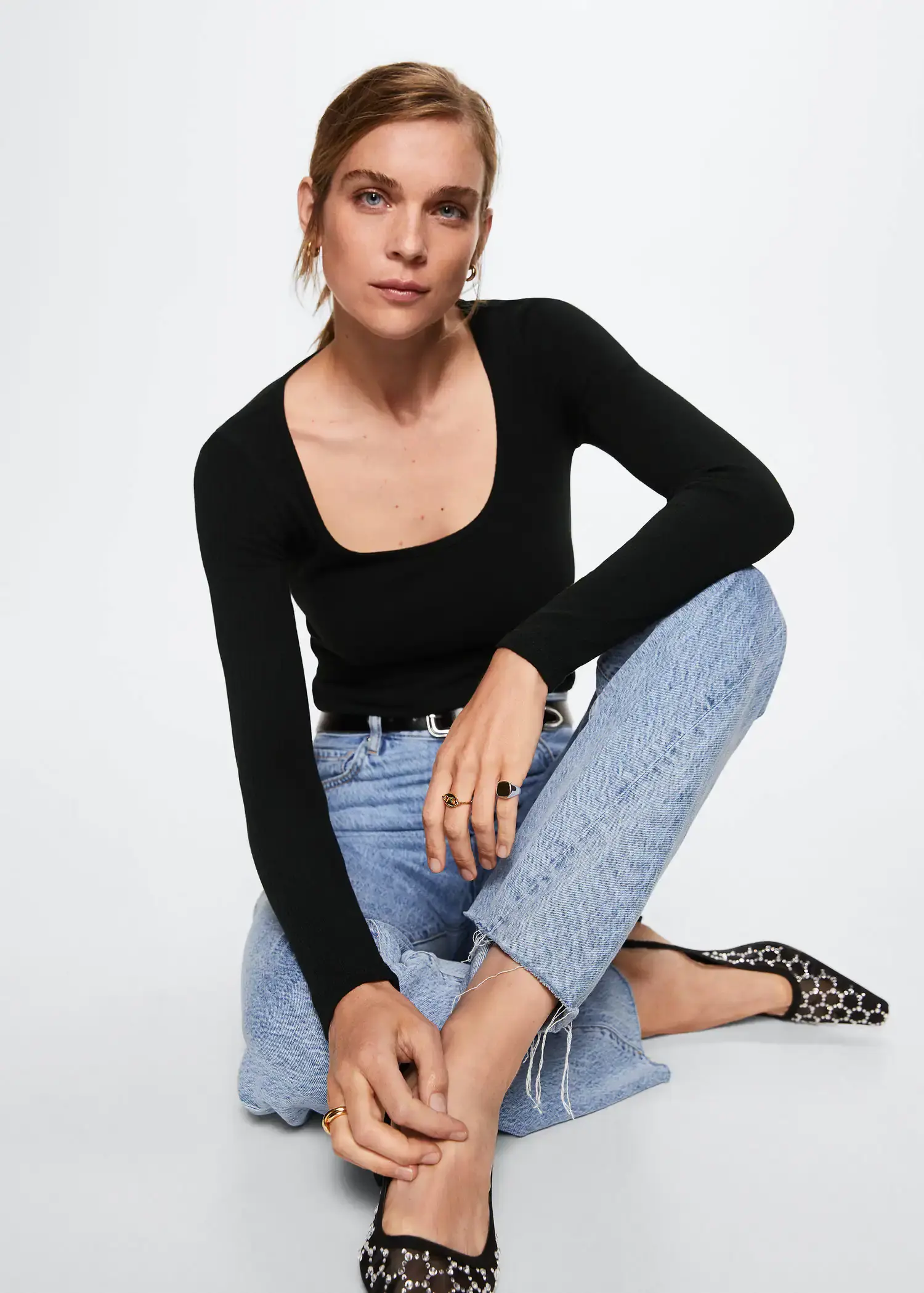 Mango Ribbed long-sleeved t-shirt. a woman sitting on the ground wearing a black top. 