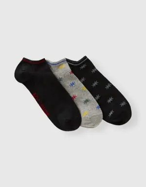 three pairs of socks with logo