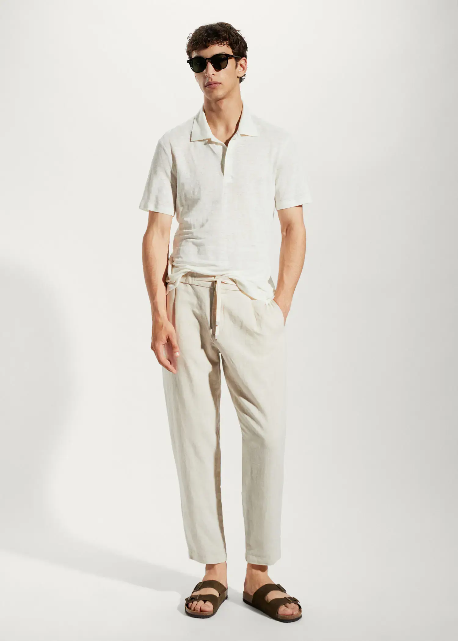 Mango Slim fit 100% linen polo shirt. a man in a white shirt and beige pants. 