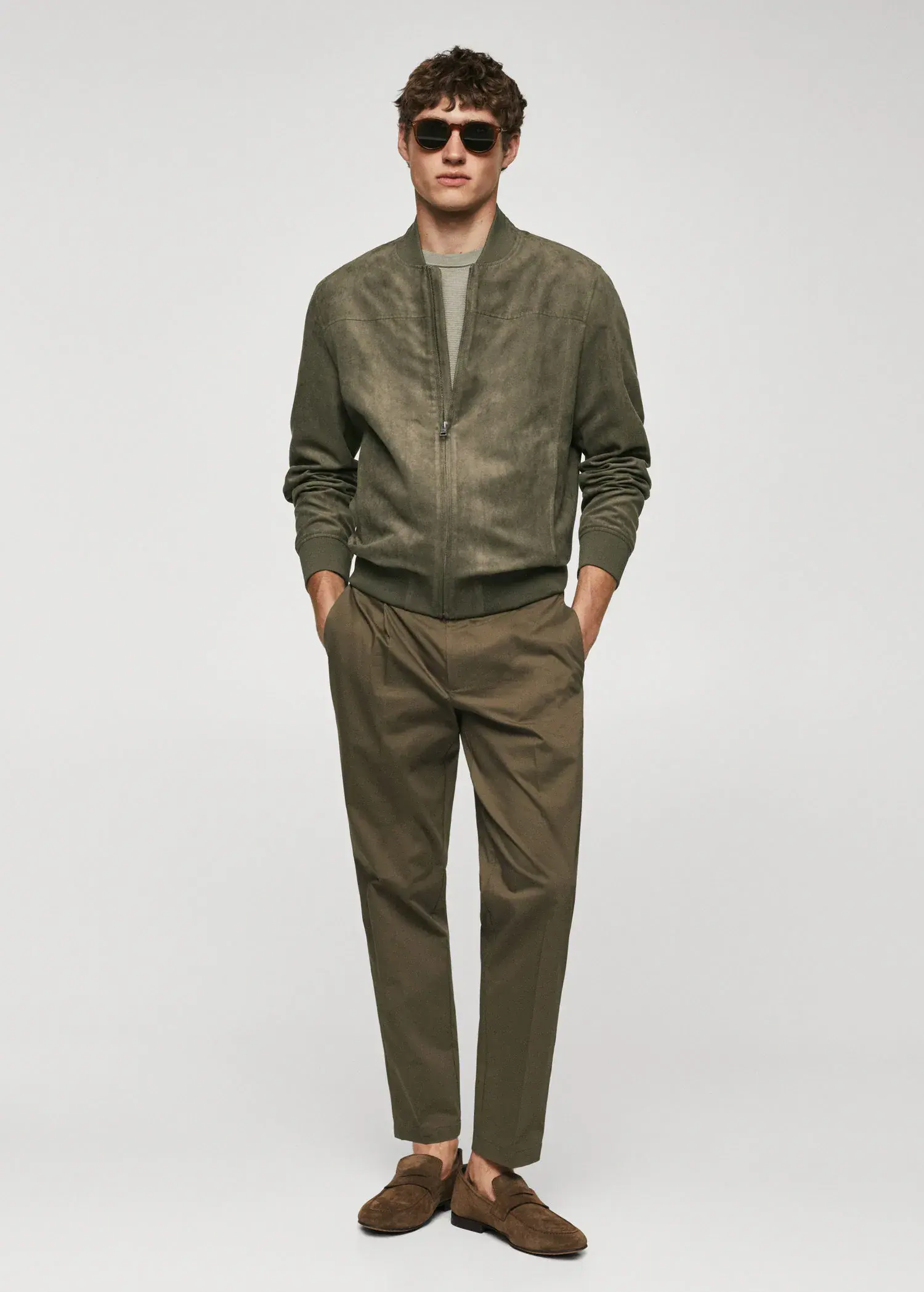 Mango Suede-effect bomber jacket. a man wearing a green jacket and a pair of green pants. 