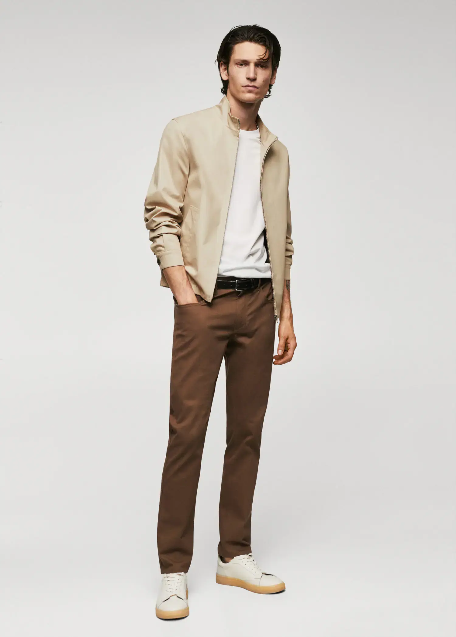 Mango 100% cotton bomber jacket. a man in a tan jacket and brown pants. 