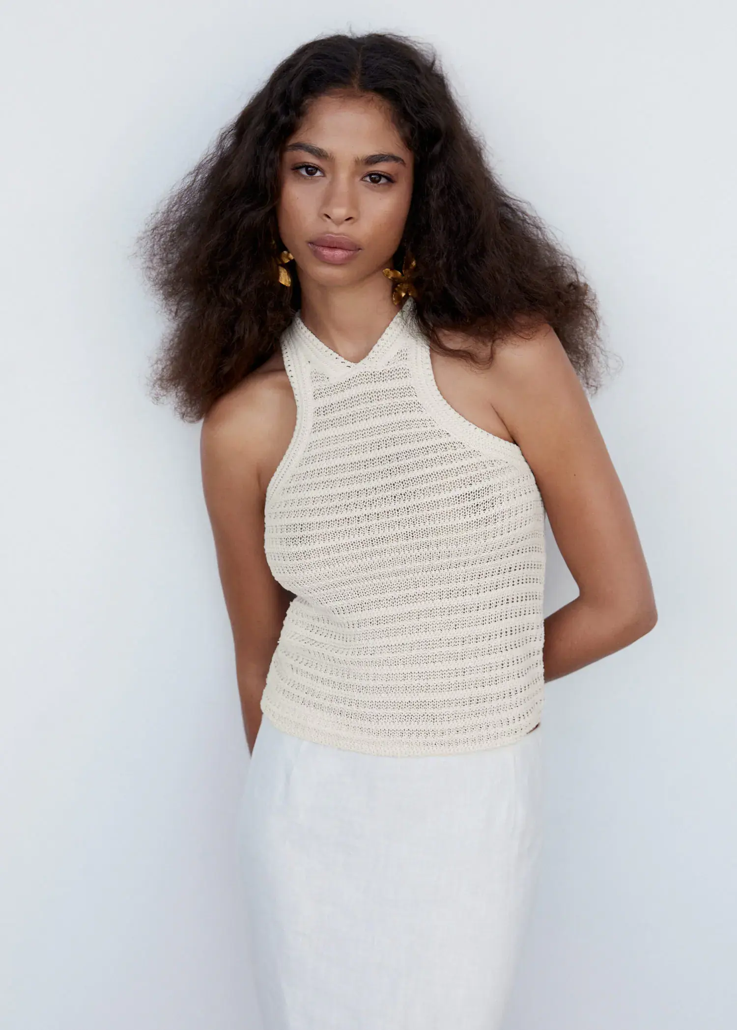 Mango Halter neck crochet top. a woman standing in front of a white wall. 