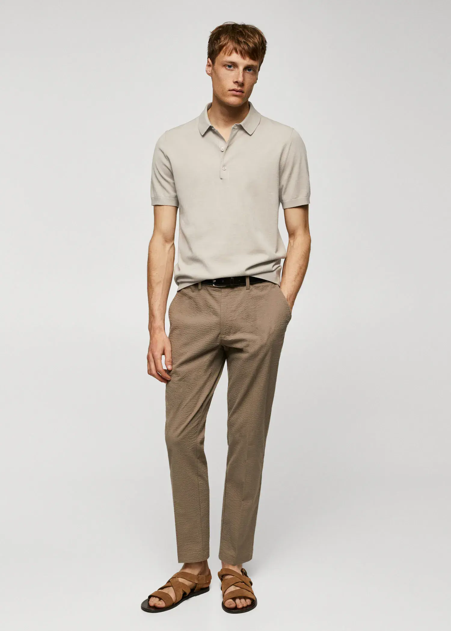 Mango Fine-knit polo shirt. a man in a beige shirt and brown pants. 