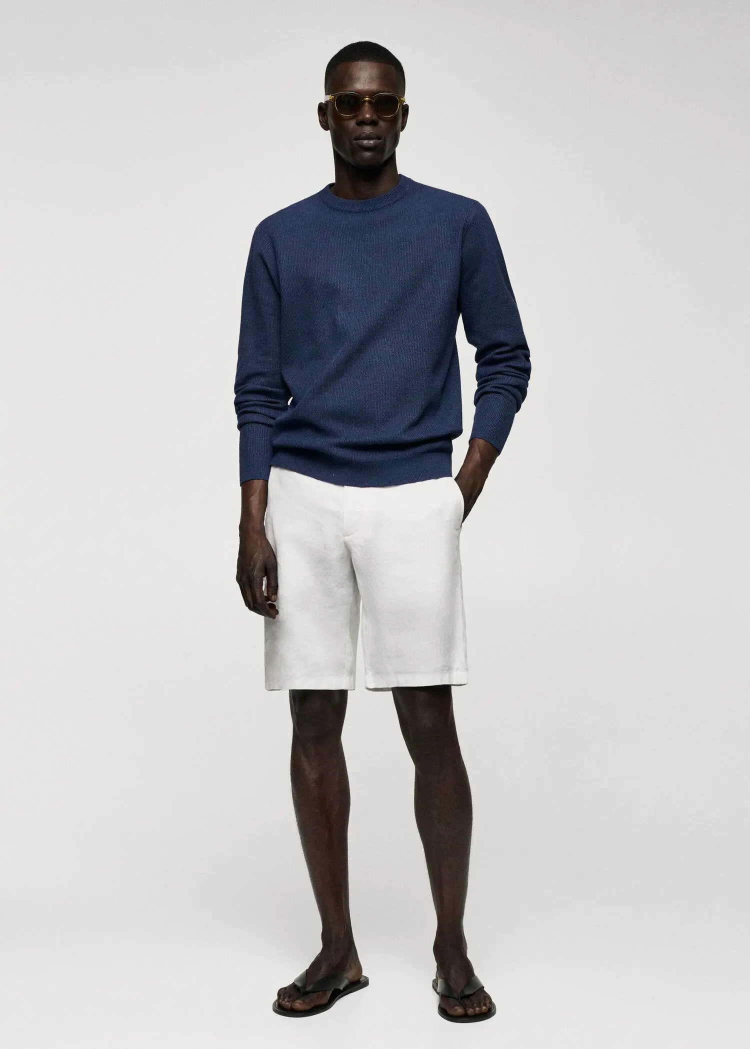 Mango Structured cotton sweater. a man in a blue sweater and white shorts. 