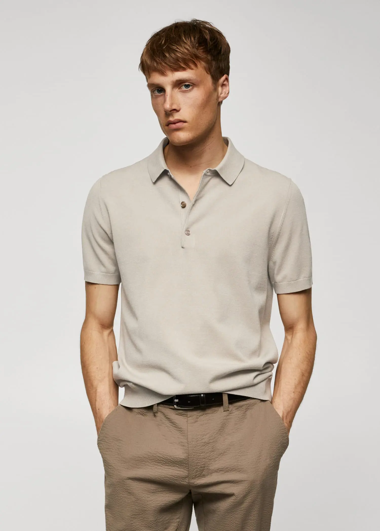 Mango Fine-knit polo shirt. a man in a beige polo shirt is posing for a picture. 