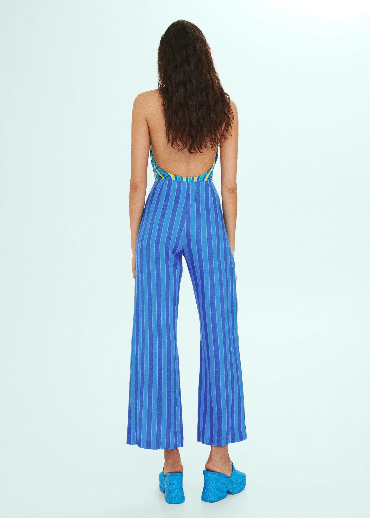 Mango Striped linen-blend pants. a woman wearing a blue and white striped jumpsuit. 