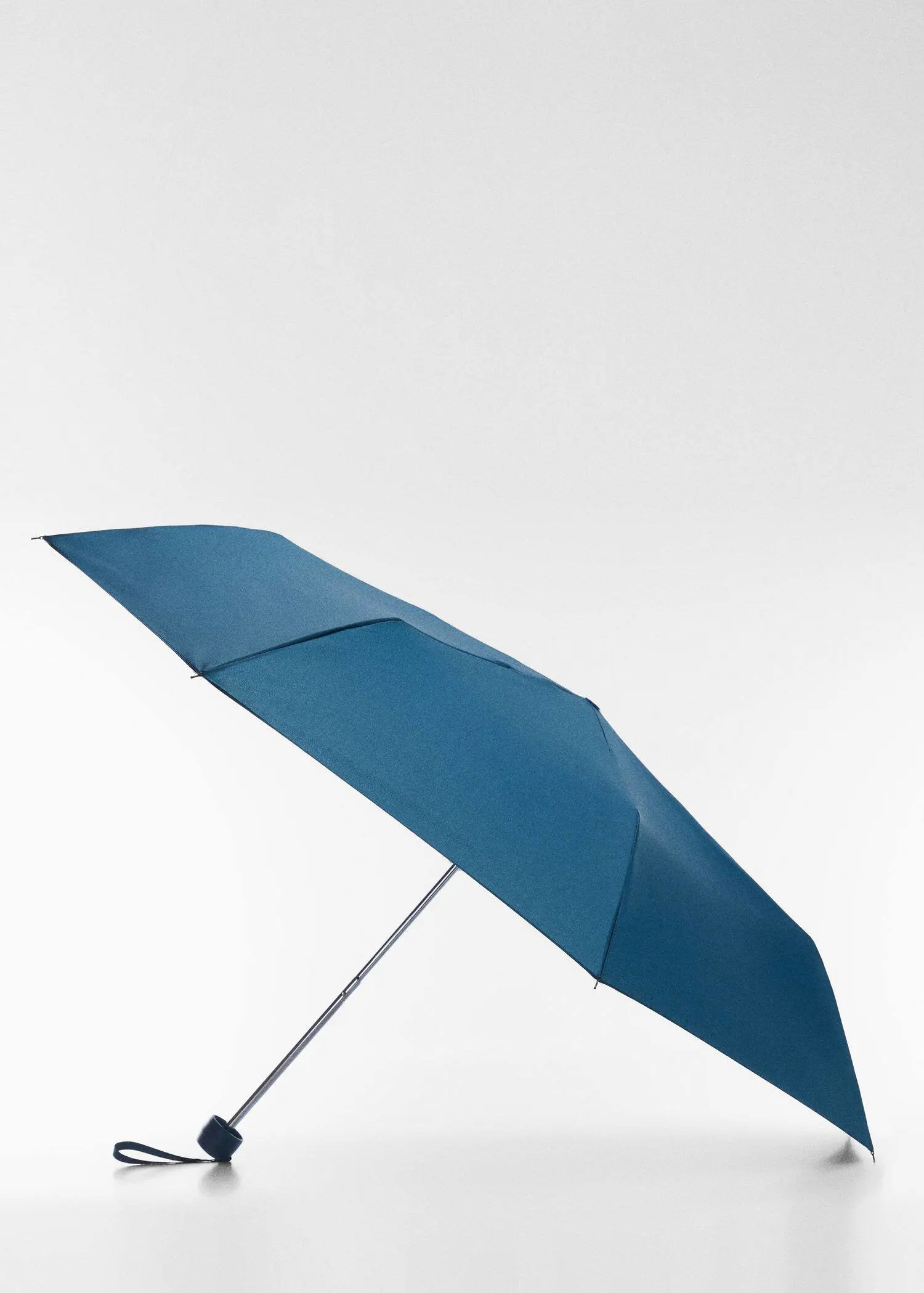 Mango Plain folding umbrella. an umbrella is open on a sunny day. 