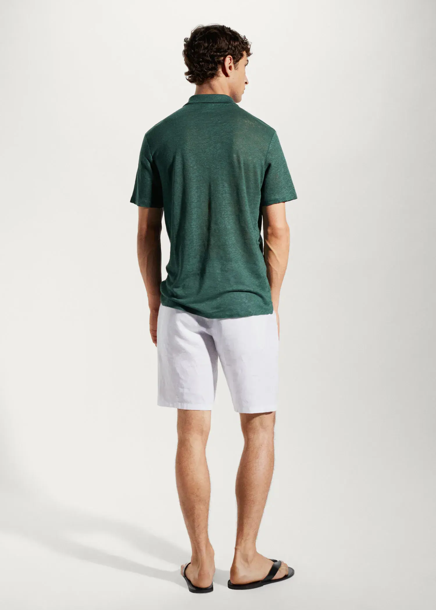 Mango Slim fit 100% linen polo shirt. a man wearing a green shirt and white shorts. 
