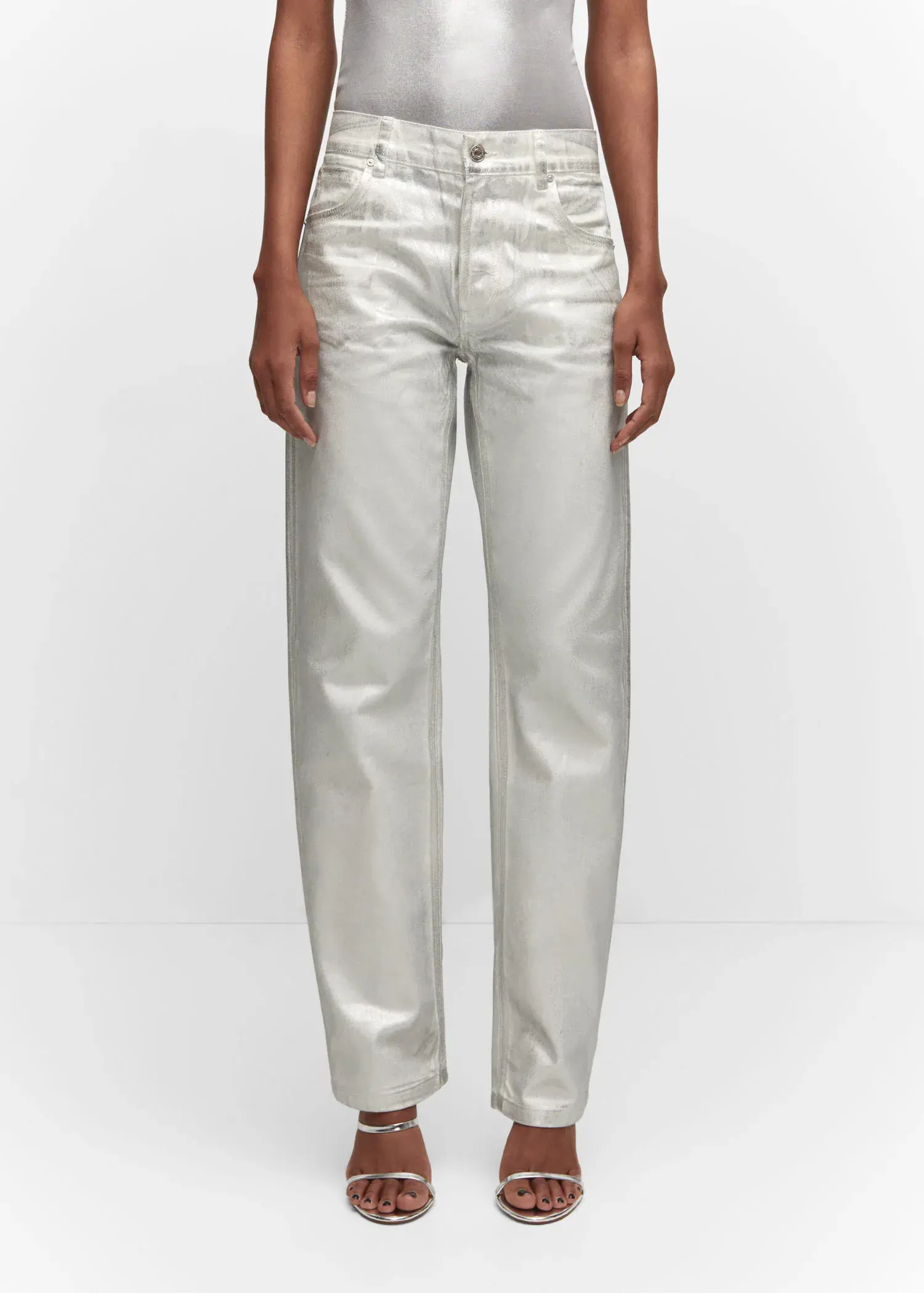 Mango Metallic straight-leg jeans. a person standing in front of a white wall. 