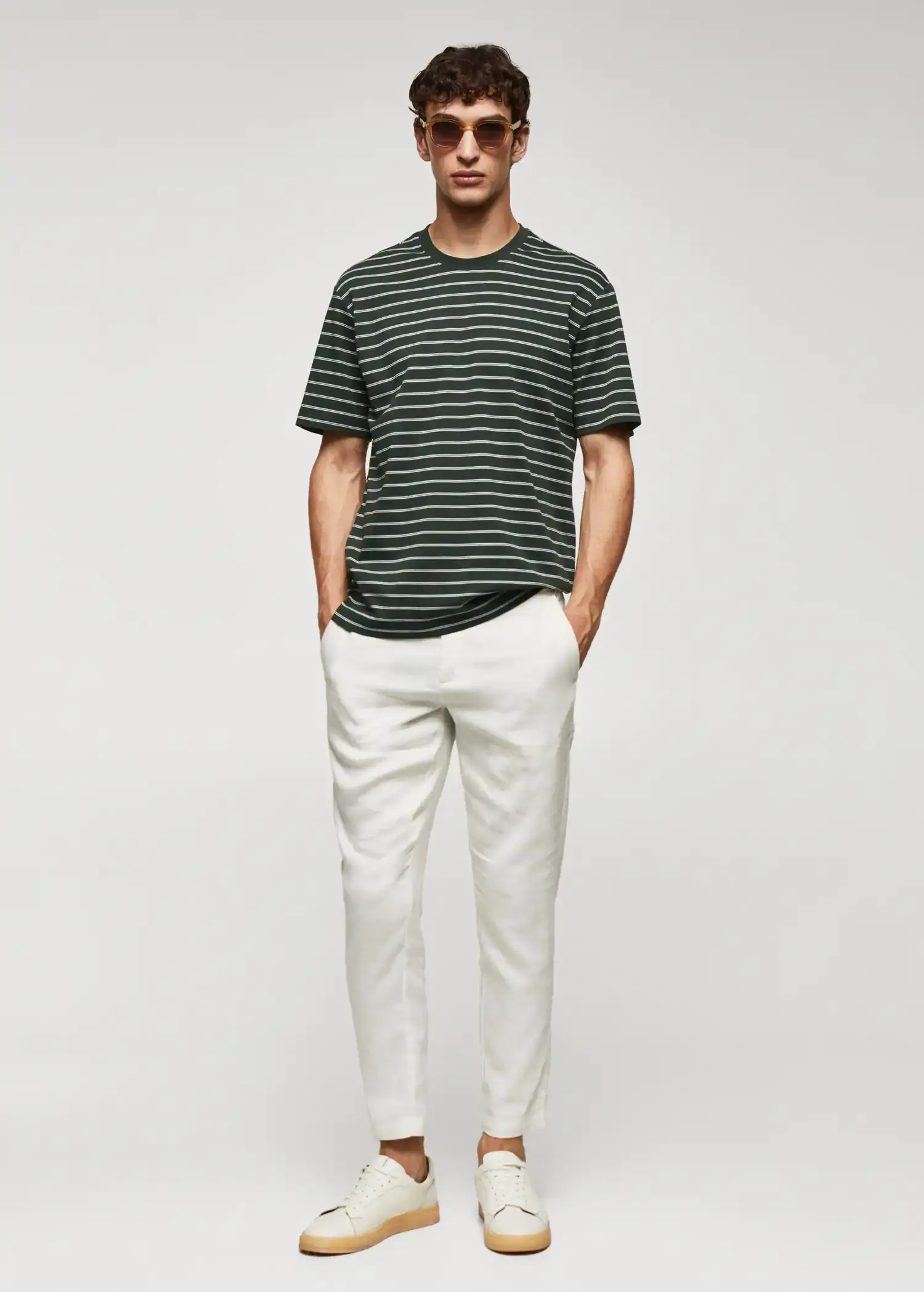 Mango Striped 100% cotton t-shirt. a man wearing a striped shirt and white pants. 