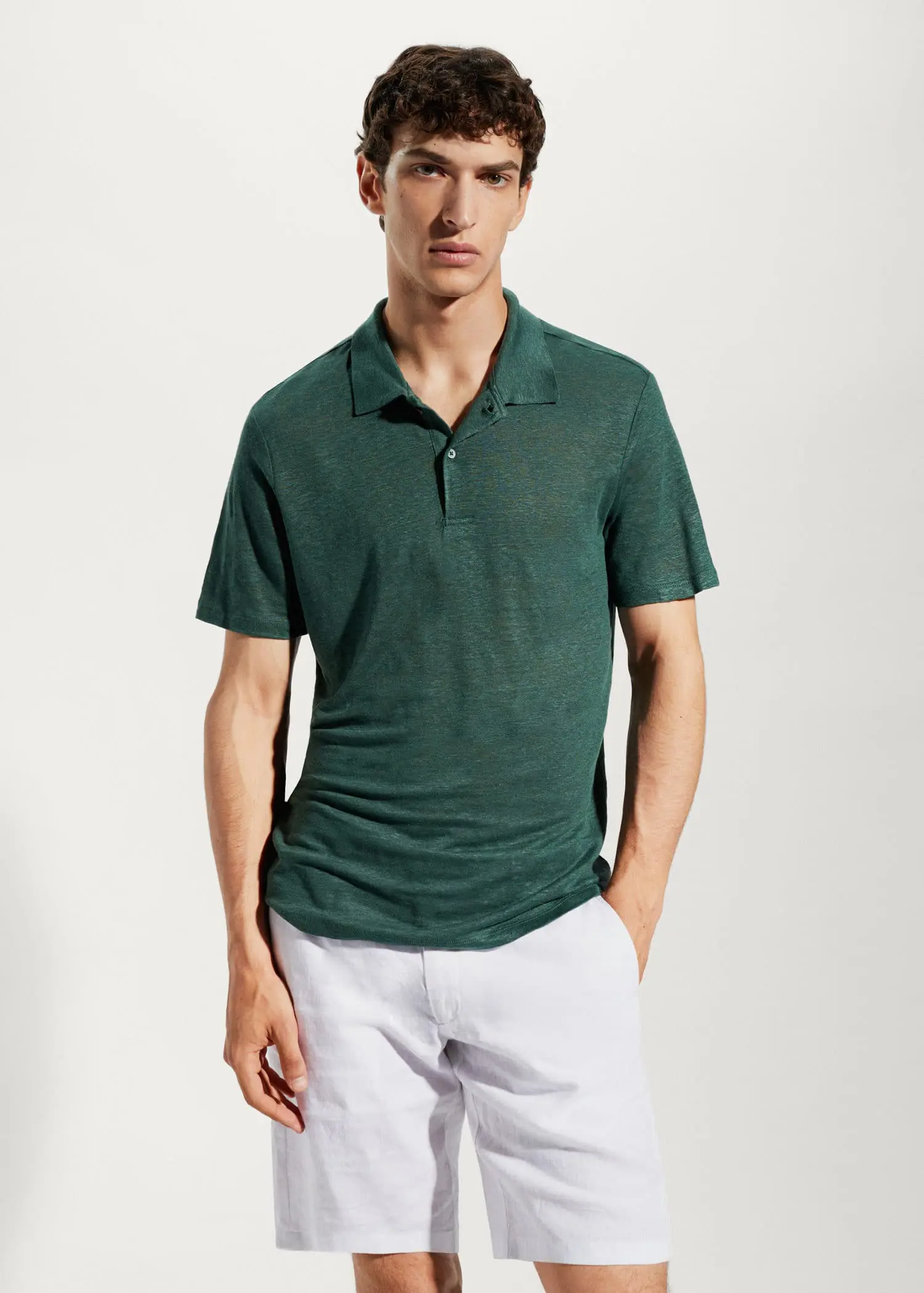 Mango Slim fit 100% linen polo shirt. a young man wearing a green shirt and white pants. 