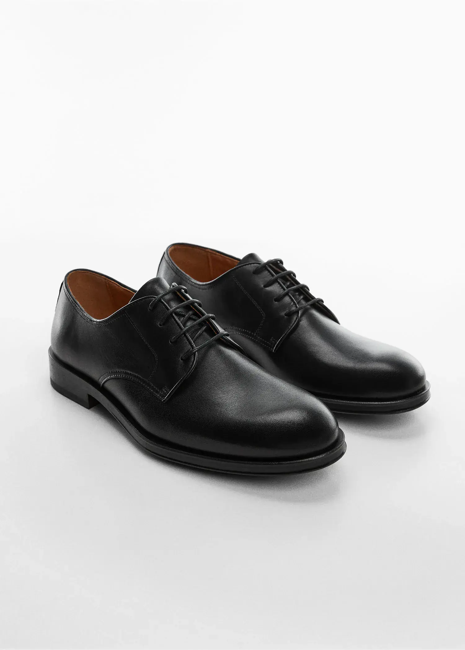 Mango Leather suit shoes. a pair of black shoes on a white surface. 