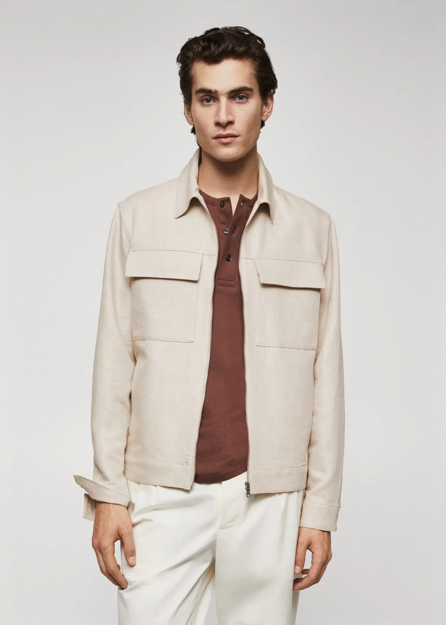 Mango Pocket linen-blend jacket. a young man wearing a tan jacket and white pants. 