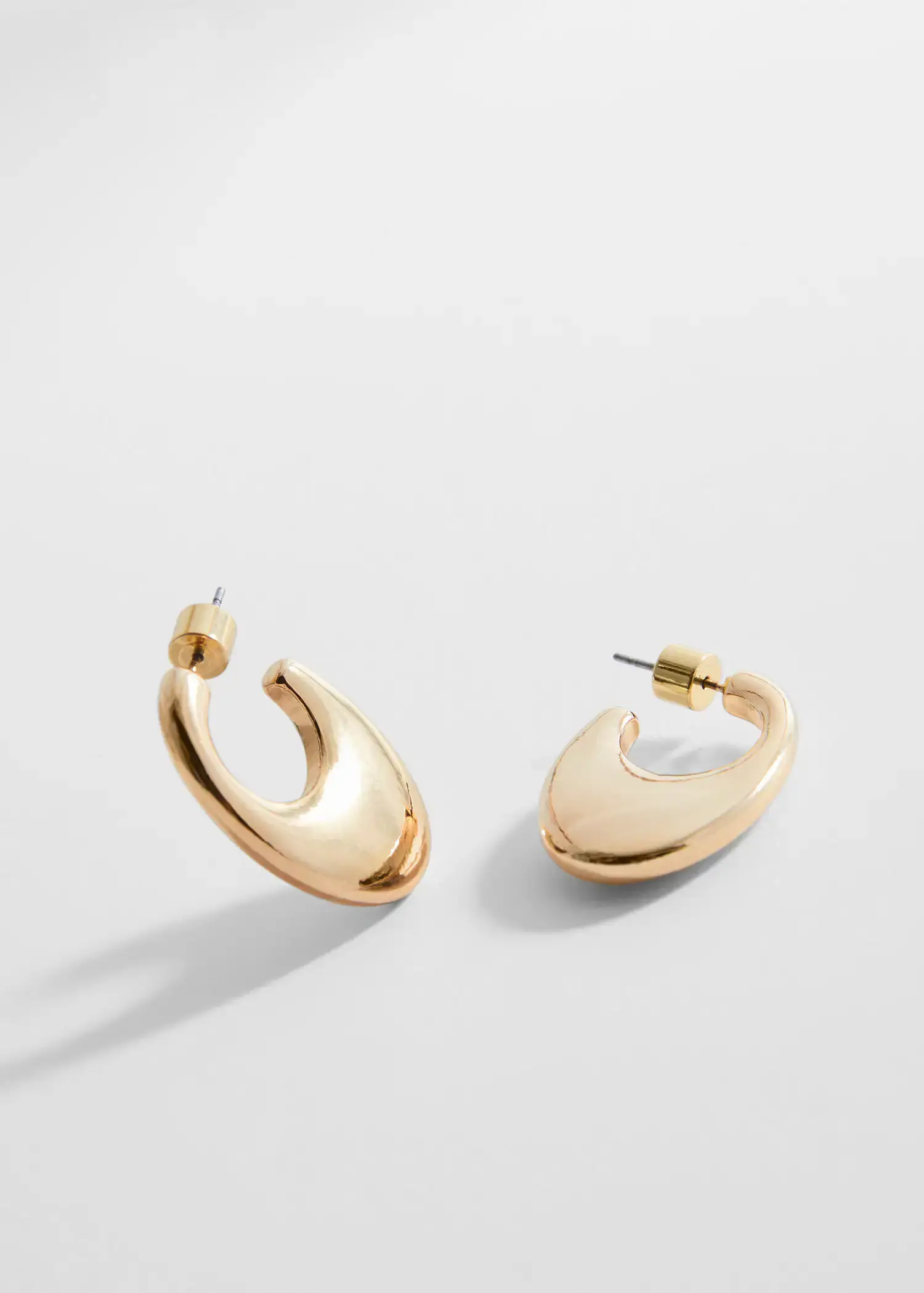Mango Oval hoop earrings. a close up of a pair of earrings 