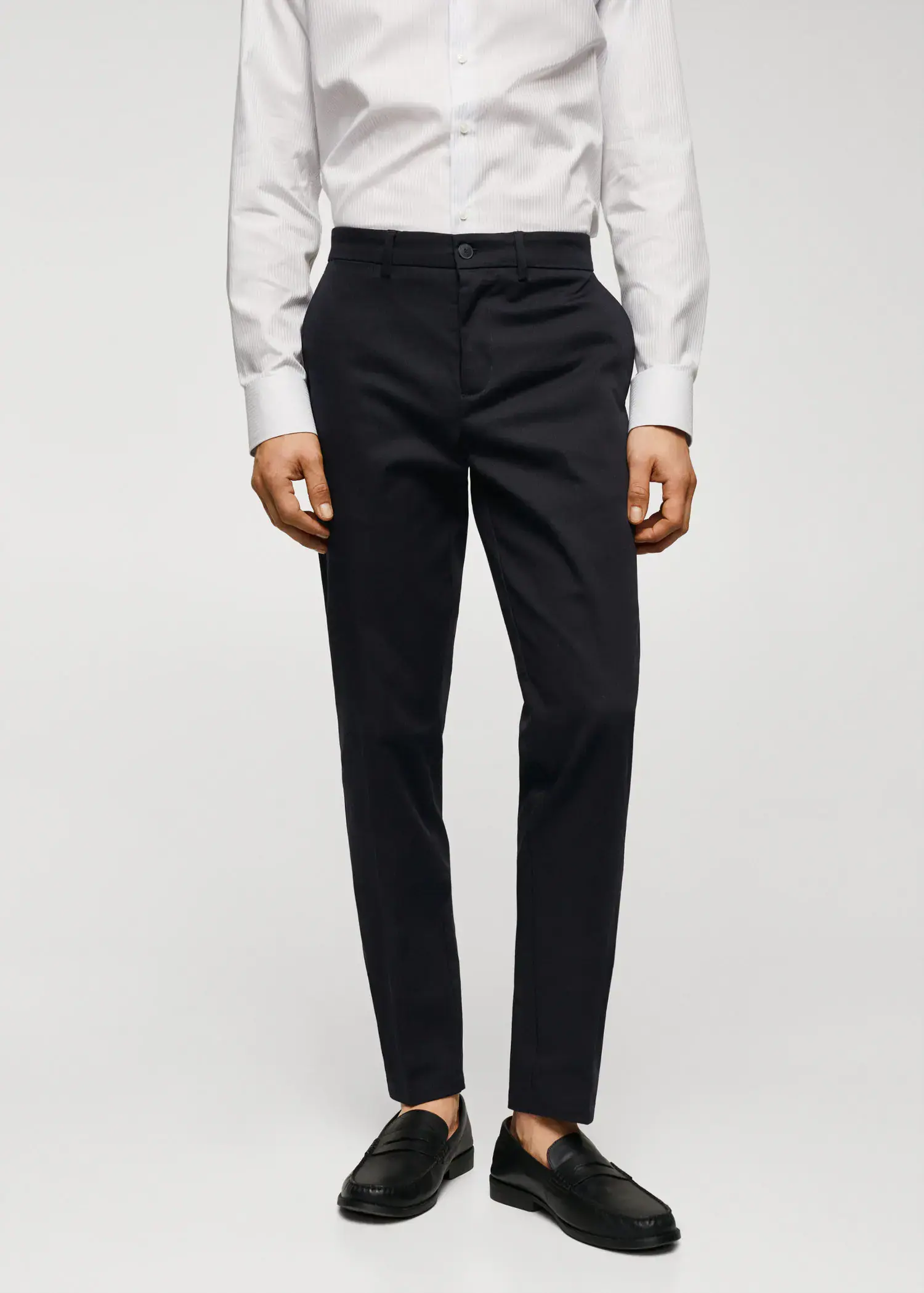 Mango Slim fit chino trousers. a man wearing a white shirt and black pants. 
