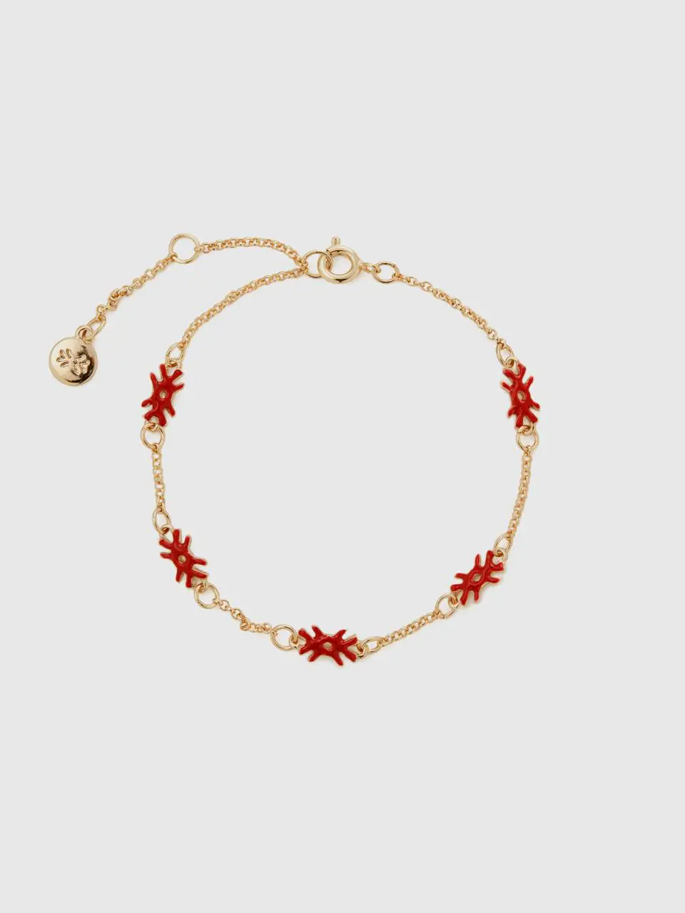 Benetton bracelet with coral red logos. 1