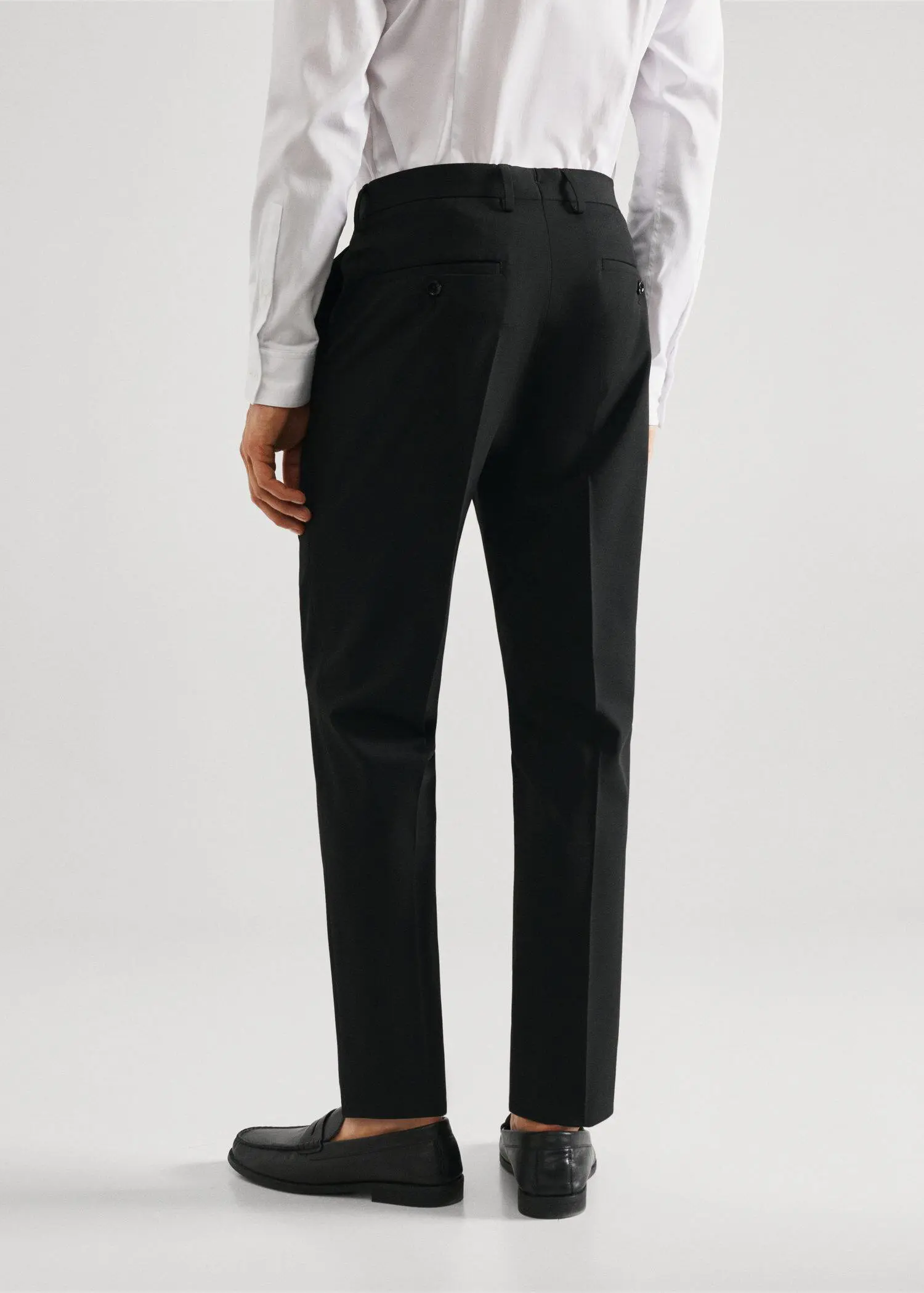 Mango Stretch fabric super slim-fit suit trousers. a person wearing a suit and tie. 