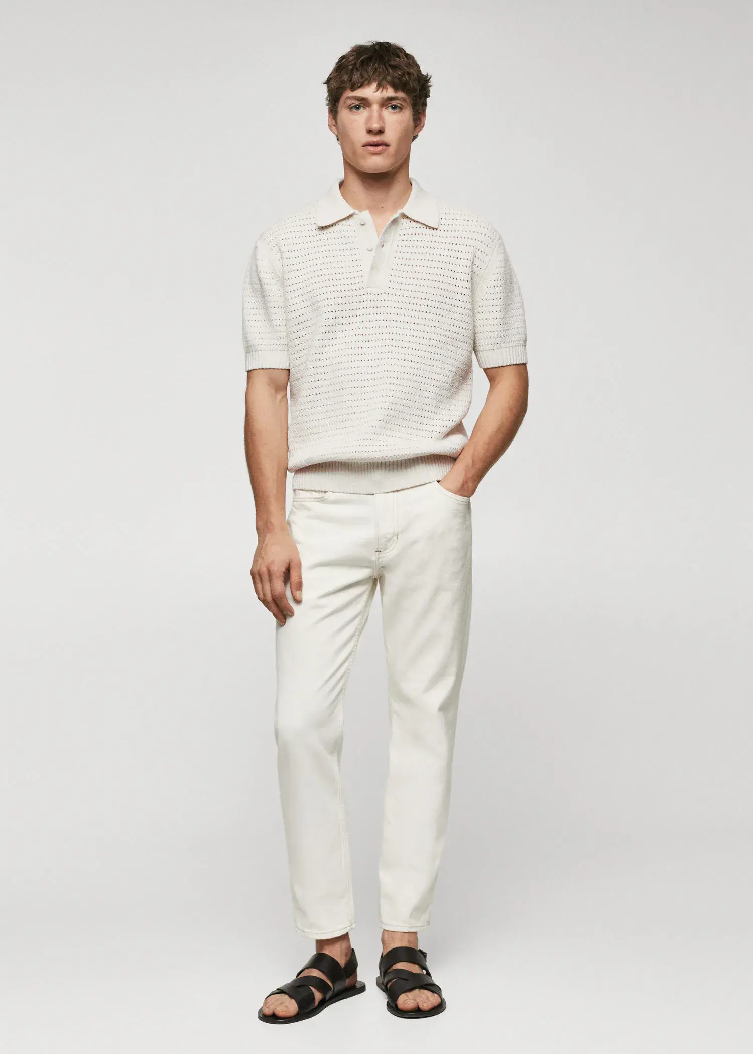 Mango Openwork knit cotton polo. a man in white pants and a white shirt. 