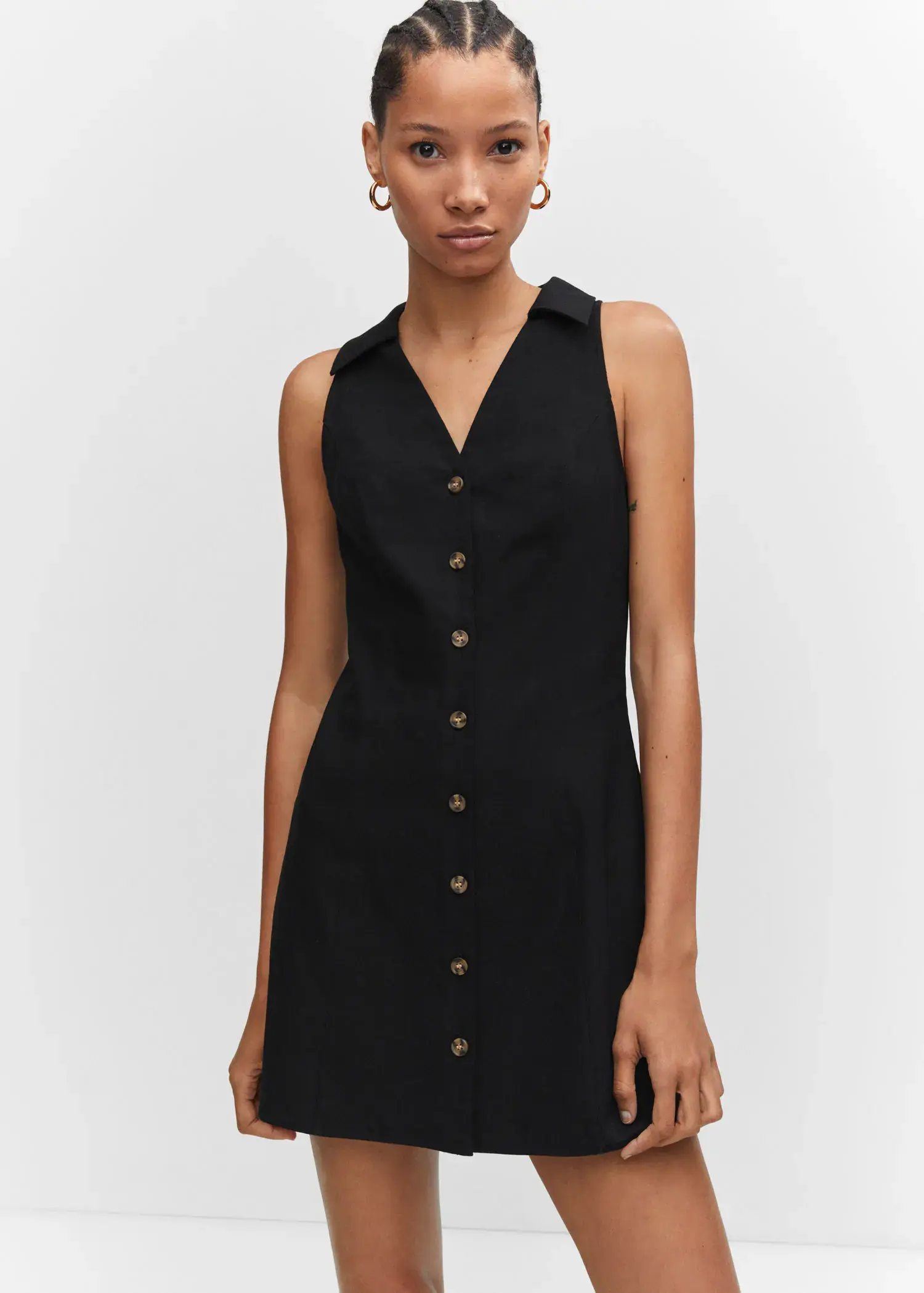Mango Ramie dress with buttons. a woman wearing a black dress with a button down front. 