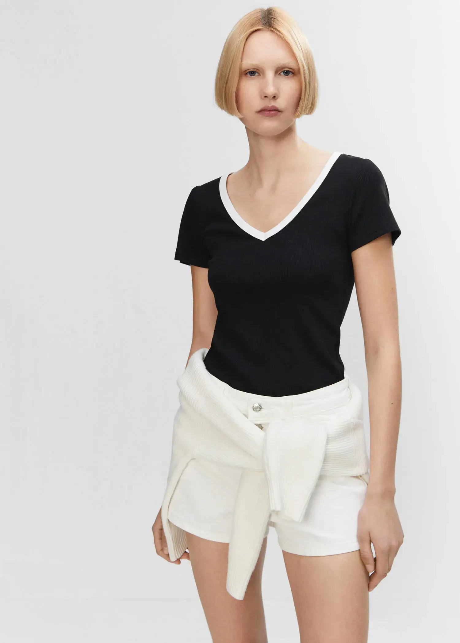 Mango Contrast collar shirt. a woman in a black shirt and white shorts. 