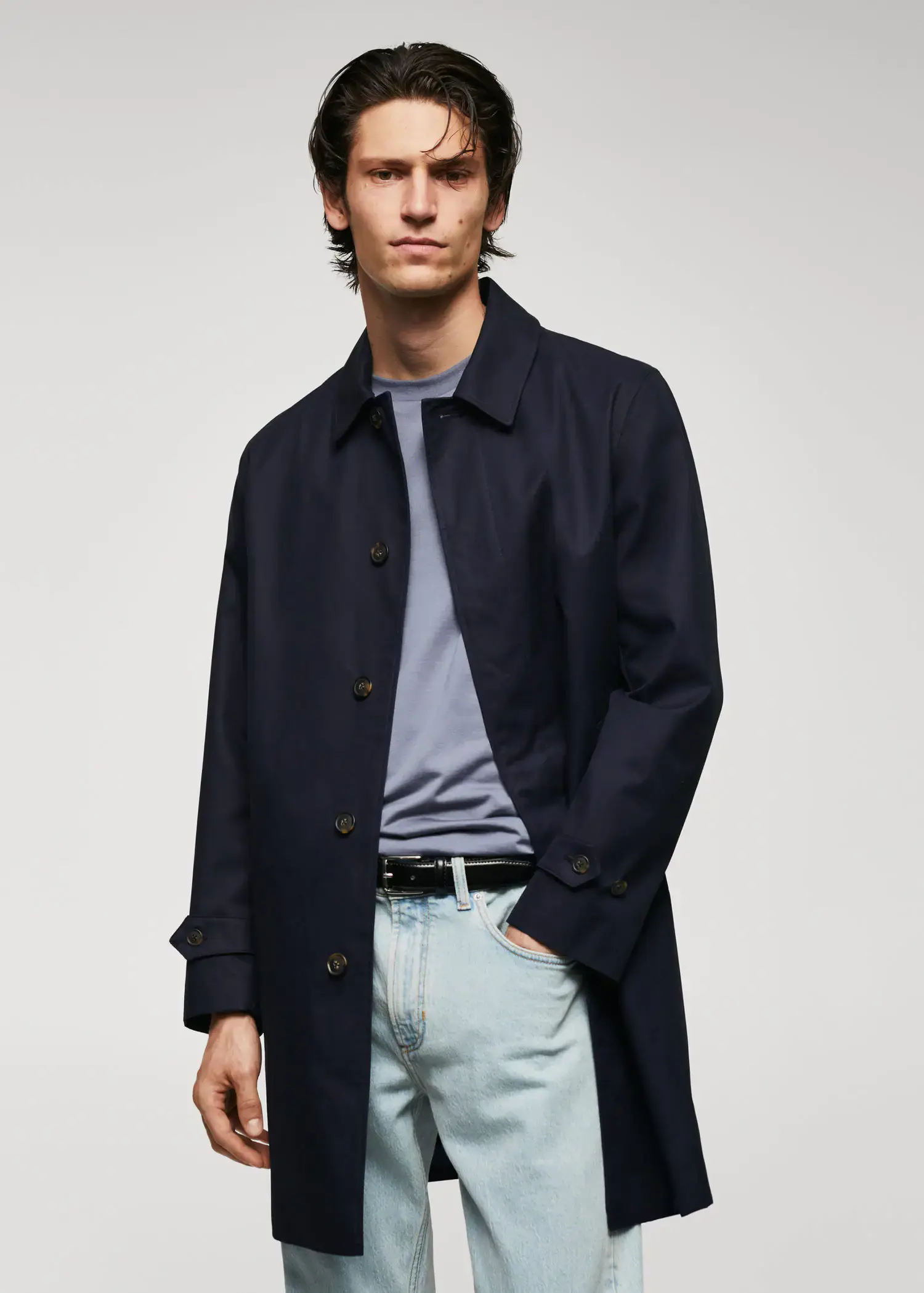 Mango Water-repellent cotton trench coat. a man wearing a black coat and blue jeans. 
