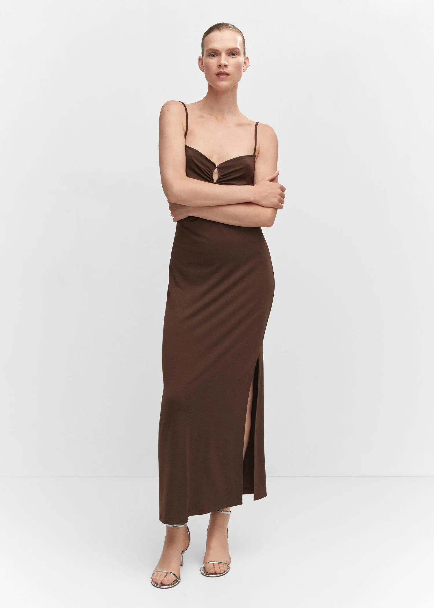 Mango Dress with pleated details and opening. a woman in a brown dress posing for a picture. 